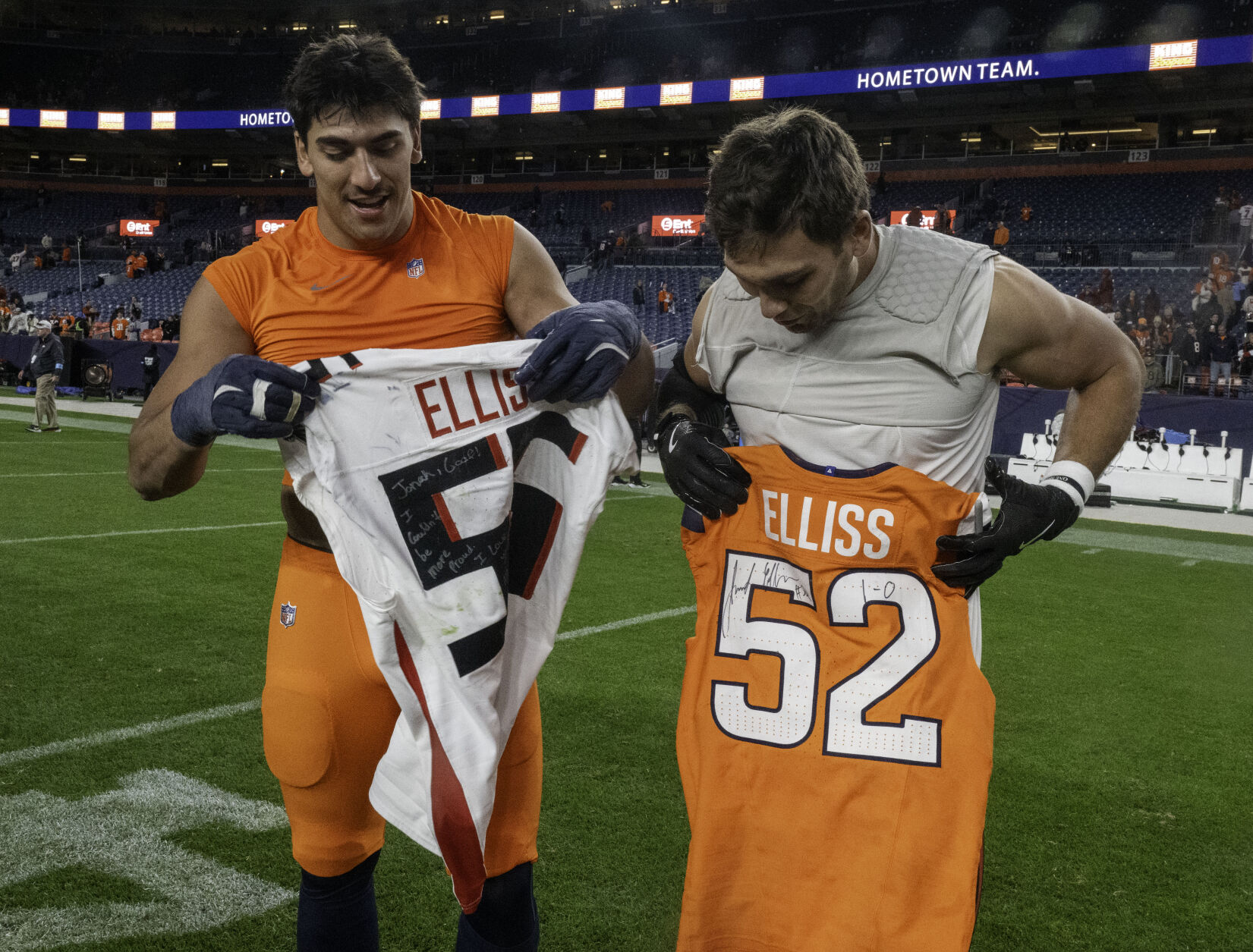Brothers Denver Broncos linebacker Jonah Elliss (52) and Atlanta Falcons linebacker Kaden Elliss (55)(left to right) trade jerseys after a game at Empower Field at Mile High on Sunday, Nov. 17, 2024.