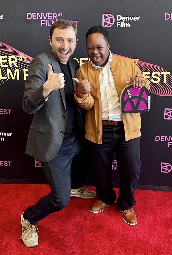 Denver Film Artistic Director Matt Campbell celebrates with Jeremiah Daniels of Aurora after “Color Book” was named the 2024 juried winner of the Denver Film Festival's American Independent category. It’s a black-and-white film about a young African-American father with a young son who has Down syndrome. The jury called it