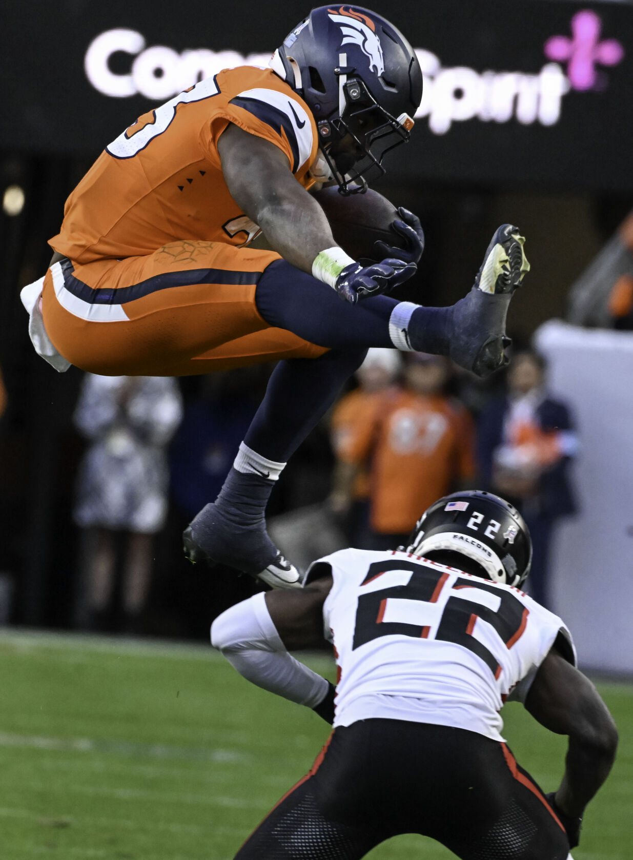 Denver Broncos running back Audric Estime (23) flies over Atlanta Falcons cornerback Clark Phillips III (22) during the third quarter of a game at Empower Field at Mile High on Sunday, Nov. 17, 2024. The Broncos defeated the Falcons 38-6. (Jerilee Bennett,The Gazette)