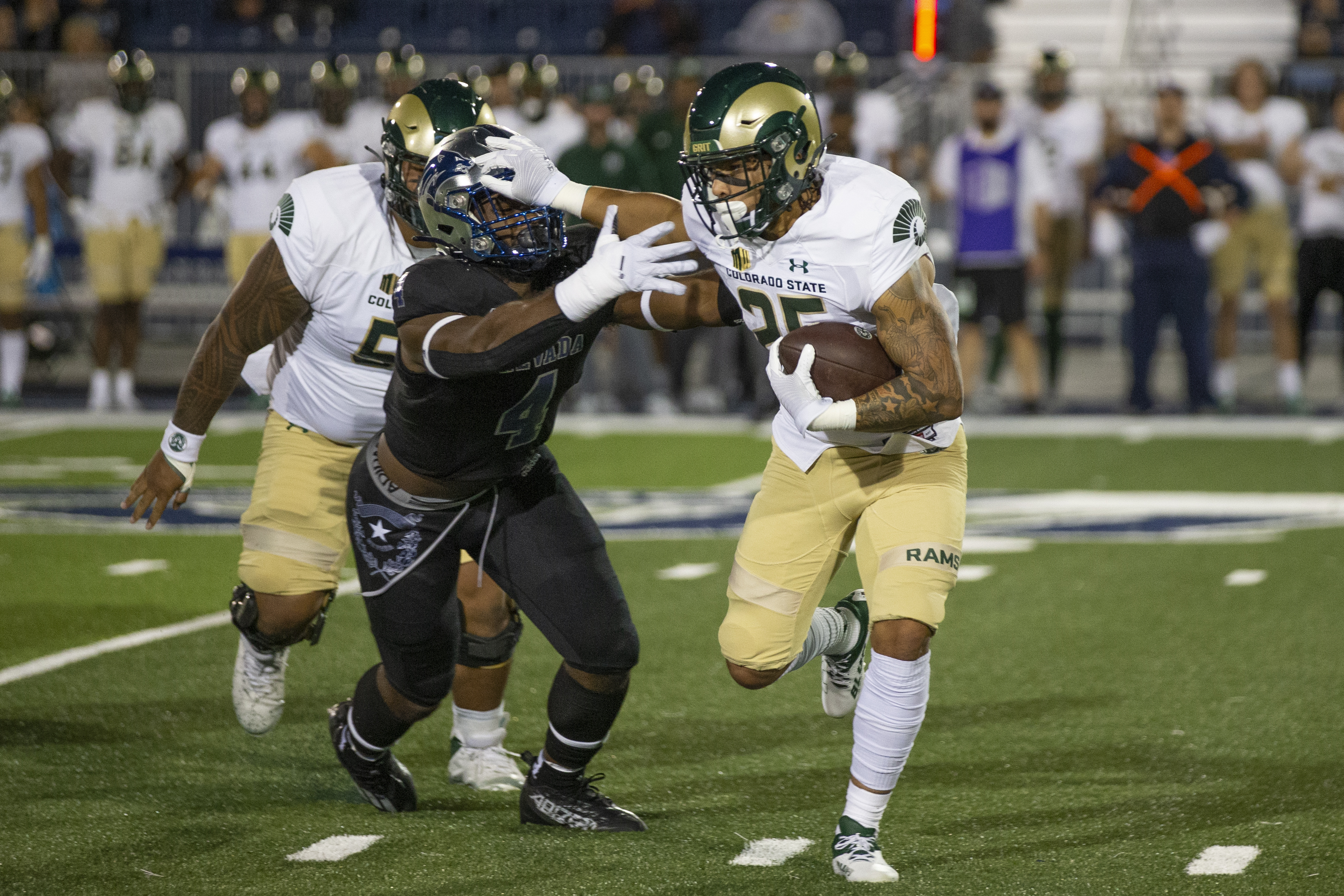 Colorado State running back Avery Morrow (25) stiff-arms Nevada linebacker Eli'jah Winston (4) iduringthe first half of an NCAA college football game in Reno, Nev., Friday, Oct. 7, 2022. (AP Photo/Tom R. Smedes) (Tom R. Smedes)