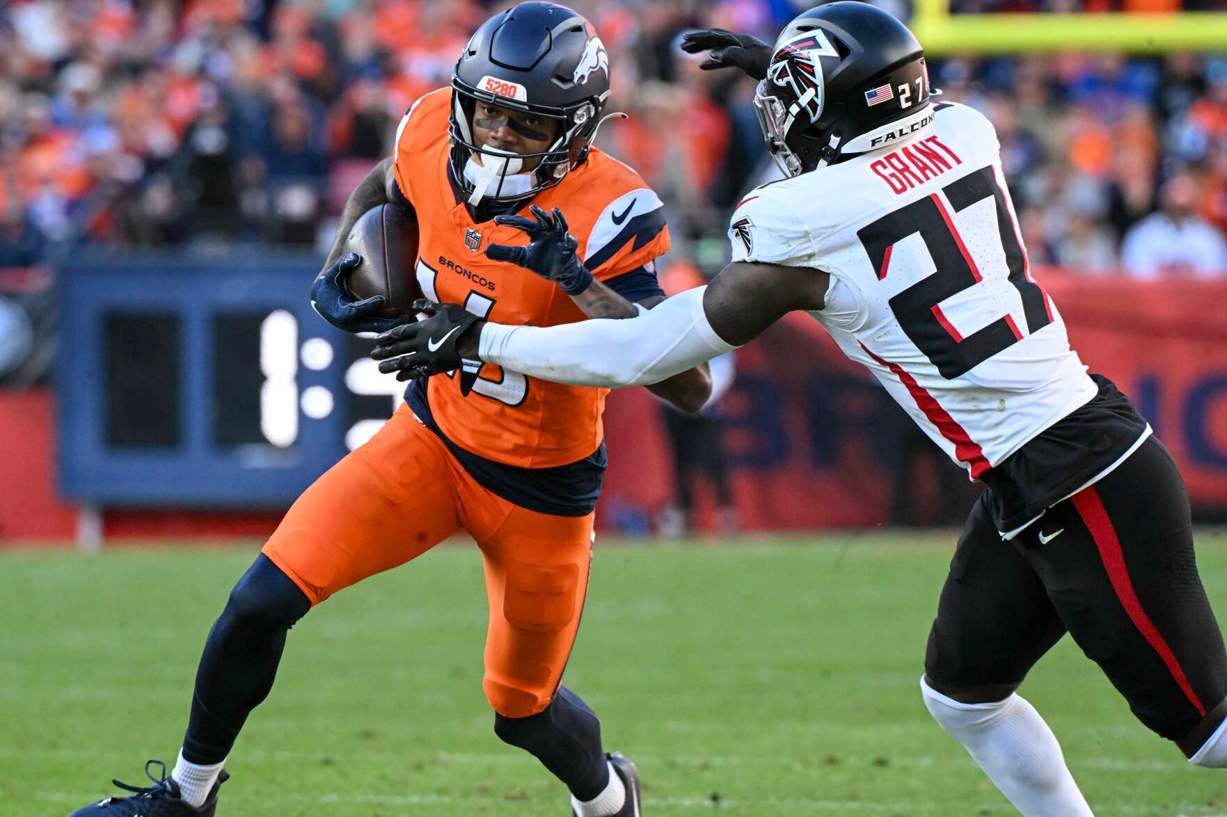 Denver Broncos wide receiver Troy Franklin (16) is pursued by Atlanta Falcons safety Richie Grant (27) during the second quarter of a game at Empower Field at Mile High on Sunday, Nov. 17, 2024. The Broncos defeated the Falcons 38-6. (Jerilee Bennett,The Gazette)