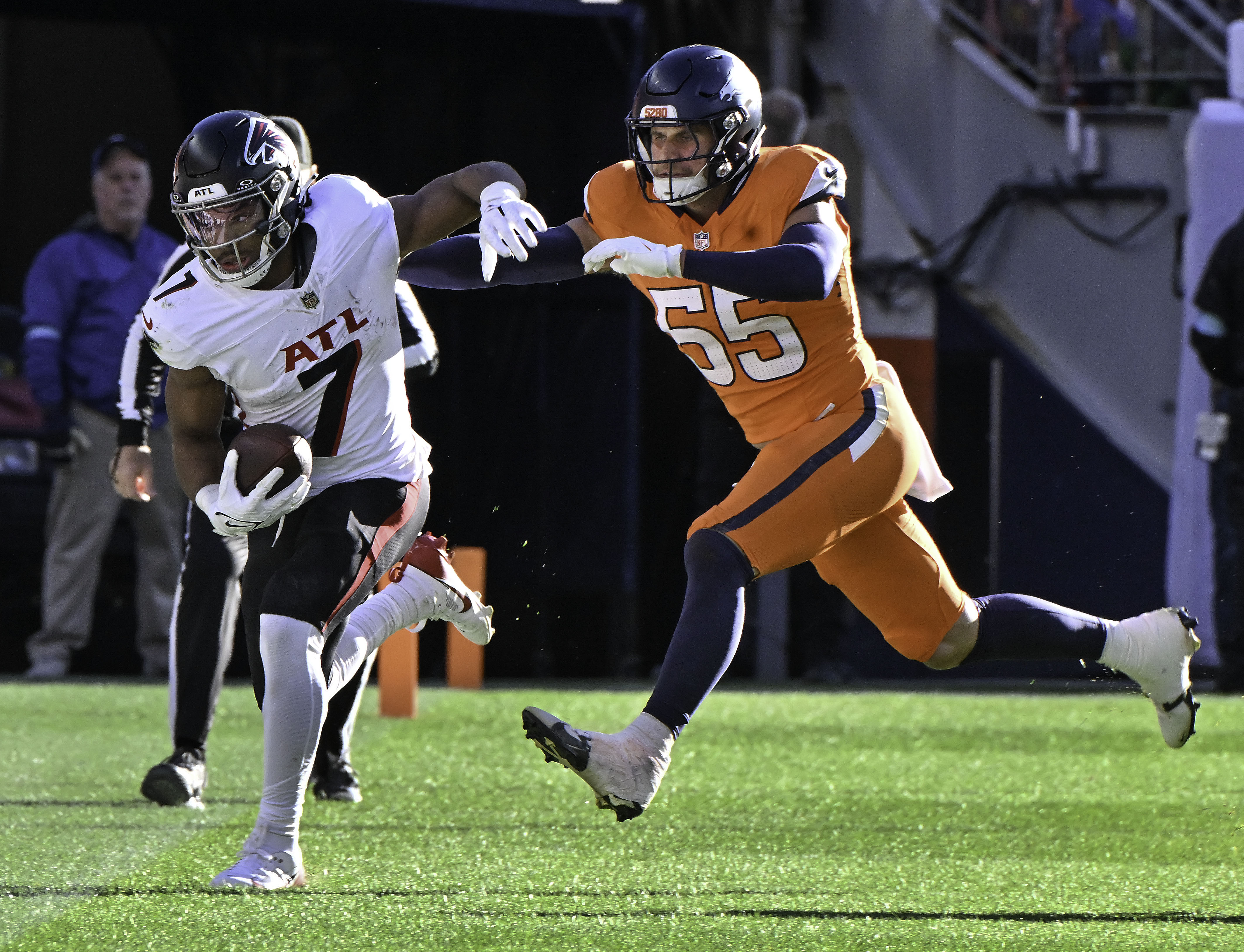 Denver Broncos linebacker Cody Barton (55) chases Atlanta Falcons running back Bijan Robinson (7) out of bounds during a game against the Falcons at Empower Field at Mile High on Sunday, Nov. 17, 2024. (Jerilee Bennett,The Gazette)