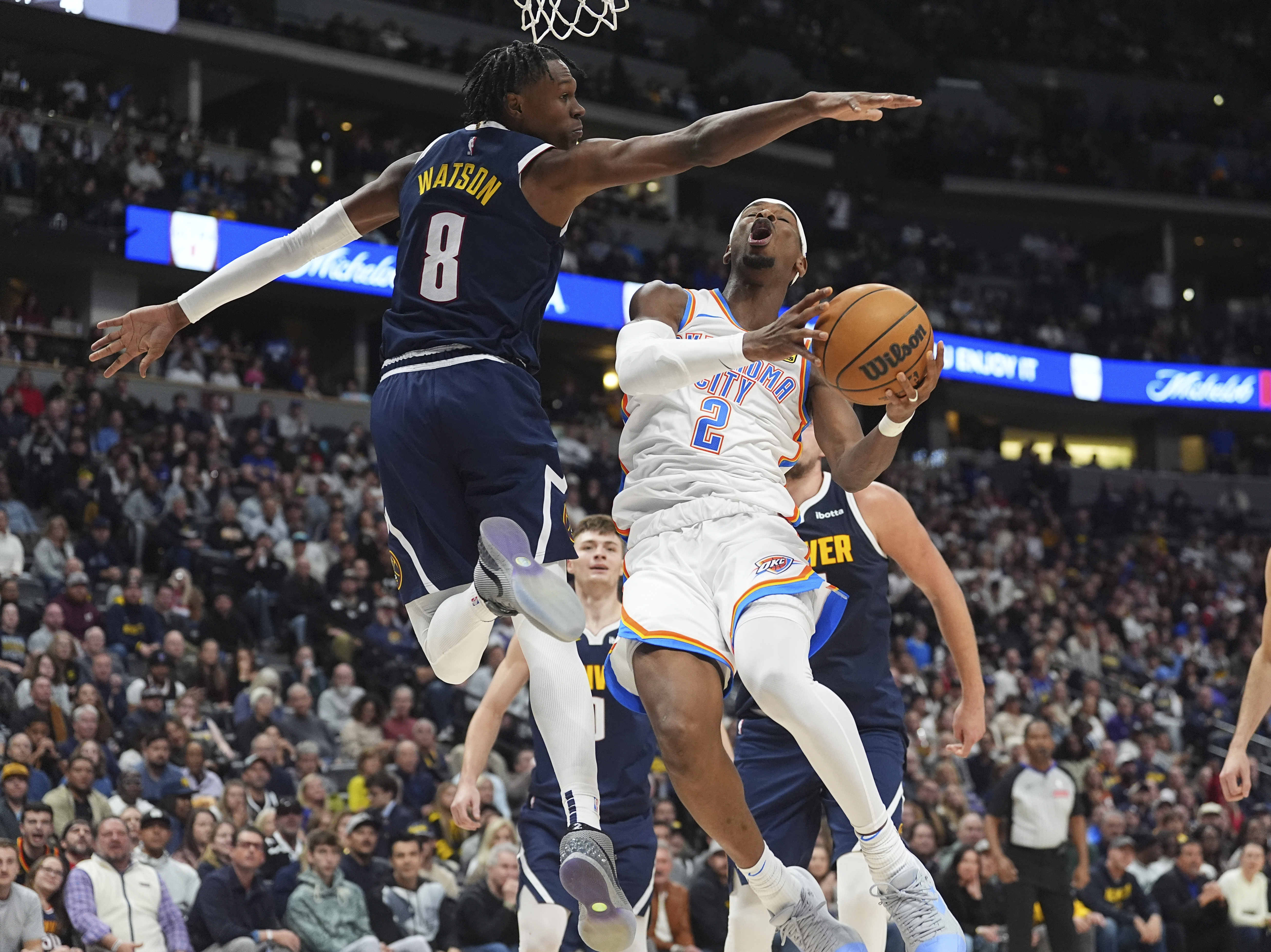 Denver Nuggets forward Peyton Watson, left, goes up to block a shot by Oklahoma City Thunder guard Shai Gilgeous-Alexander in the second half of an NBA basketball game Wednesday, Nov. 6, 2024, in Denver. (AP Photo/David Zalubowski) (David Zalubowski)