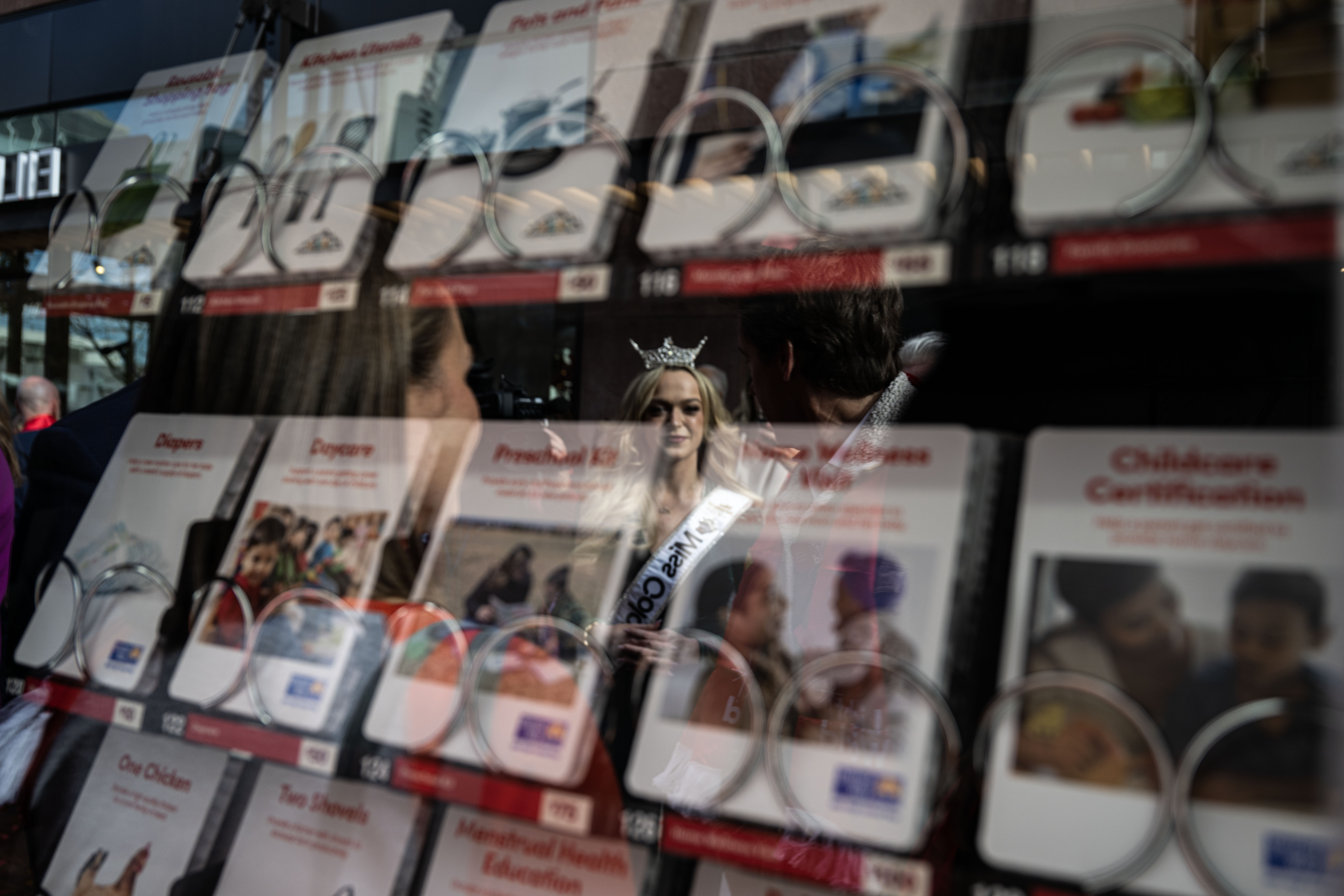 Miss Colorado Alexandra Lotko is reflected in the glass of a giving machine during an unwrapping event for Giving Machines in Cherry Creek North on Thursday, Nov. 21, 2024. The giving machines are customized vending machines that allow you to donate directly to one of five local/Denver-metro charities or two global charities. (Stephen Swofford, Denver Gazette) (StephenSwoffordPhotographerstephen.swofford@gazette.comhttps://secure.gravatar.com/avatar/1ddcaf11c5d70eaa58546ddc4e038687?d=mm&r=g)