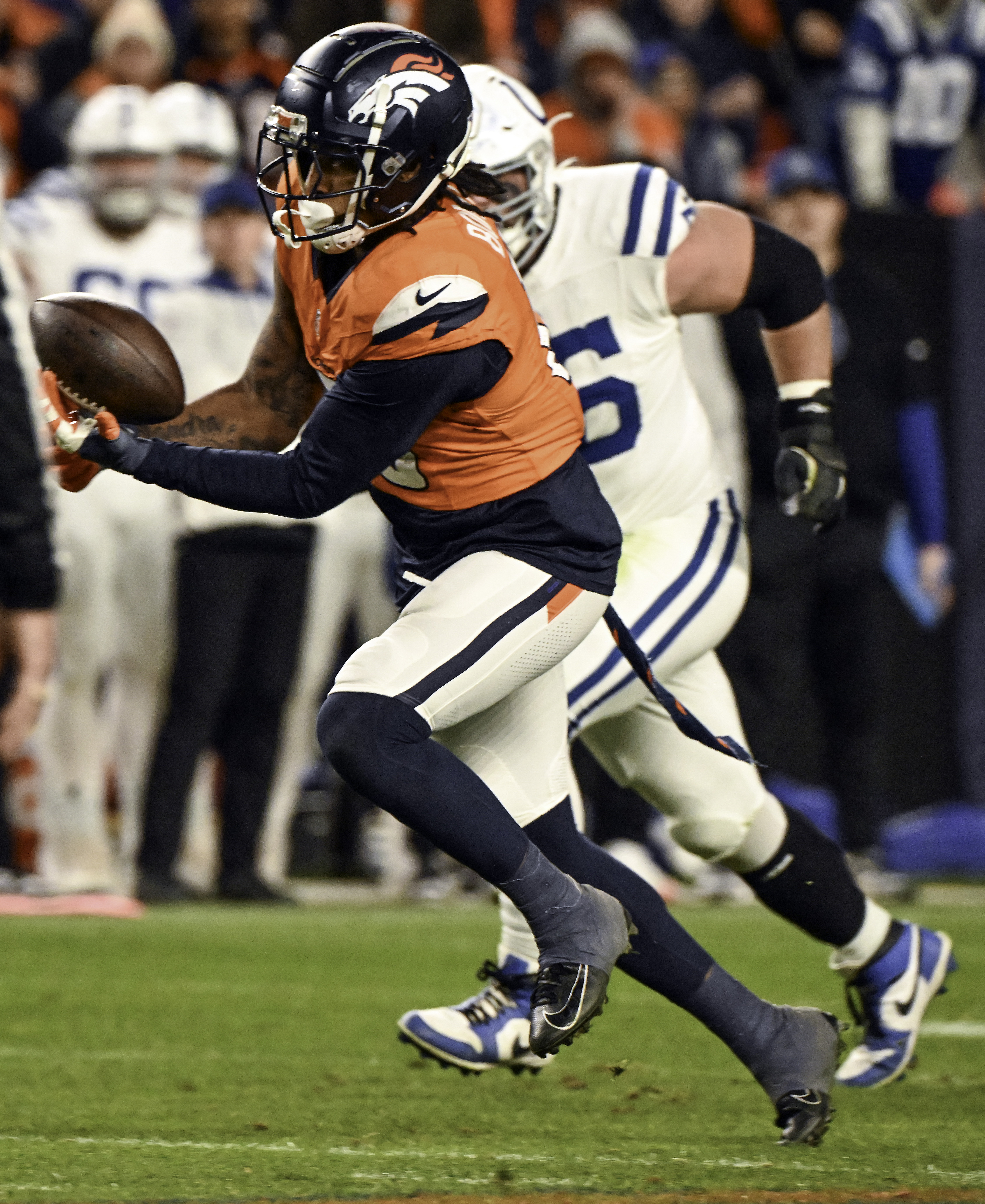 Denver Broncos linebacker Nik Bonitto (15) intercepts the ball and is chased byIndianapolis Colts quarterback Anthony Richardson (5) during the second half of a game against the Colts. Bonitto scored a touchdown on the interception. The Broncos defeated the Colts 31-13 at Empower Field at Mile High on Sunday, Dec. 15, 2024. (Jerilee Bennett, The Gazette)