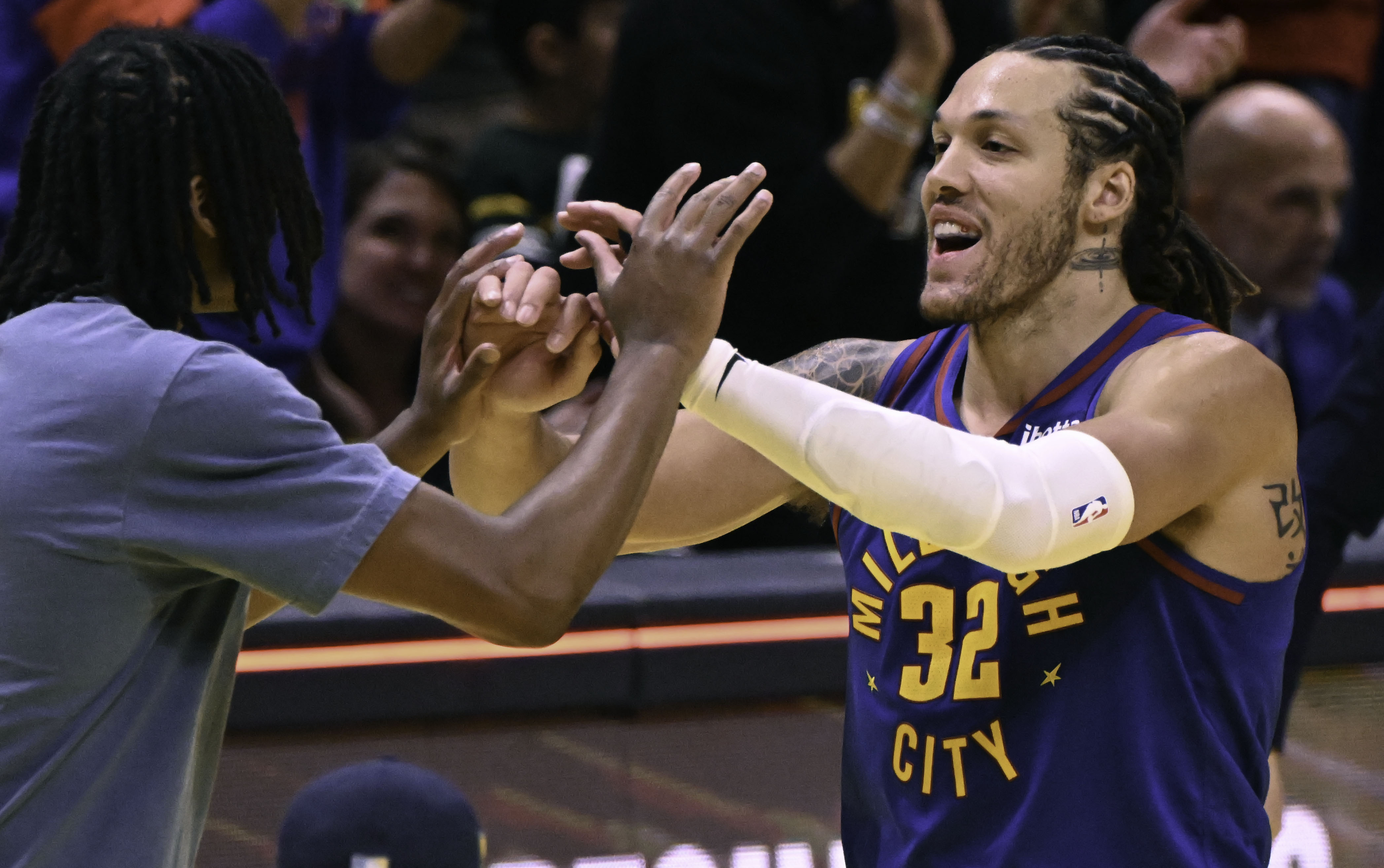 Denver Nuggets forward Aaron Gordon (32) high fives with teammates after his first game back as a starter after a calf injury. The game was an Emirates NBA Cup Group Play game at Ball Arena on Tuesday, Dec. 3, 2024. The Nuggets defeated the Warriors 119-115. (Jerilee Bennett, The Gazette)