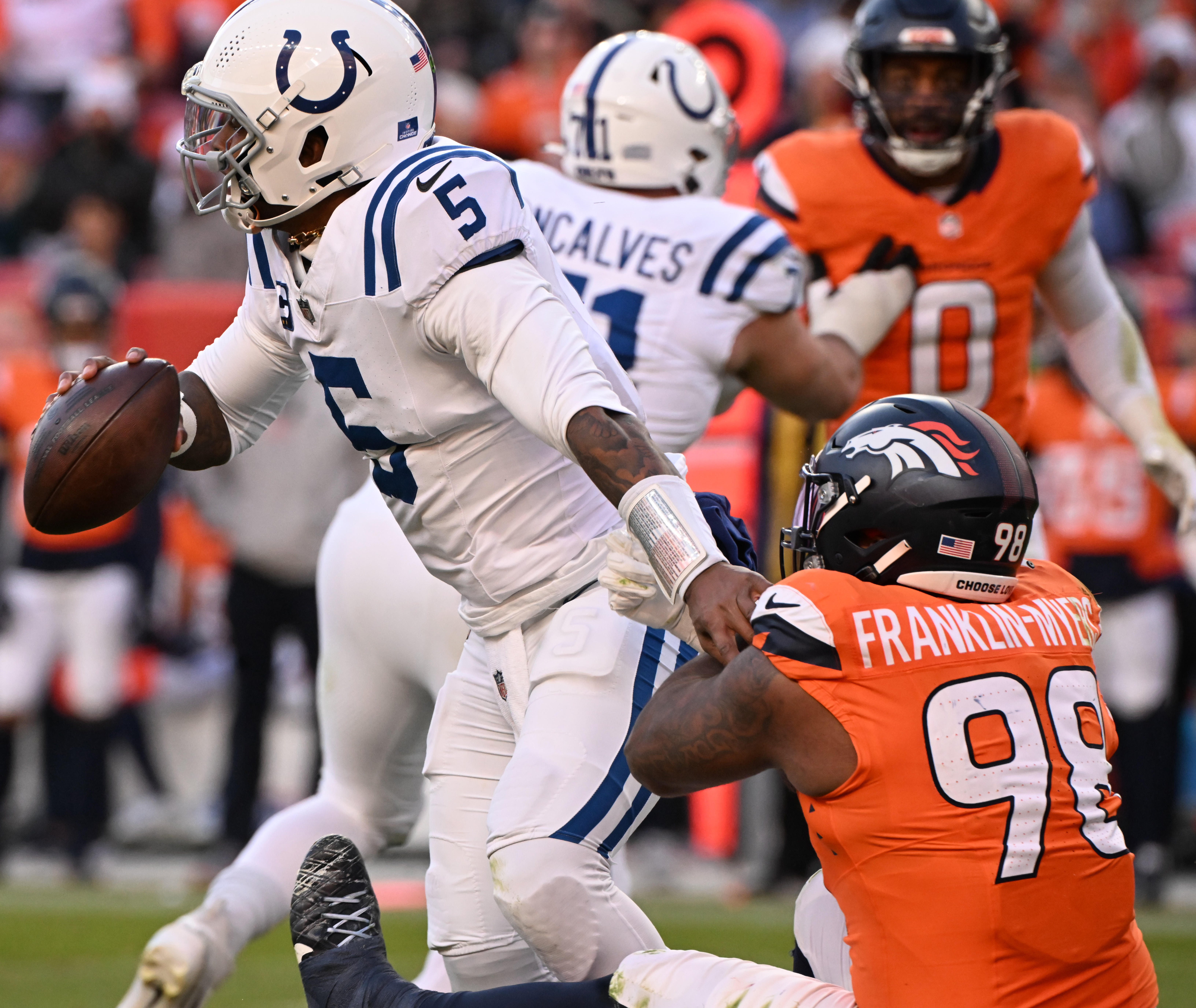 Denver Broncos defensive end John Franklin-Myers (98) put pressure on Indianapolis Colts quarterback Anthony Richardson (5) during the second quarter of a game.The Broncos defeated the Colts 31-13 at Empower Field at Mile High on Sunday, Dec. 15, 2024. (Jerilee Bennett,The Gazette)