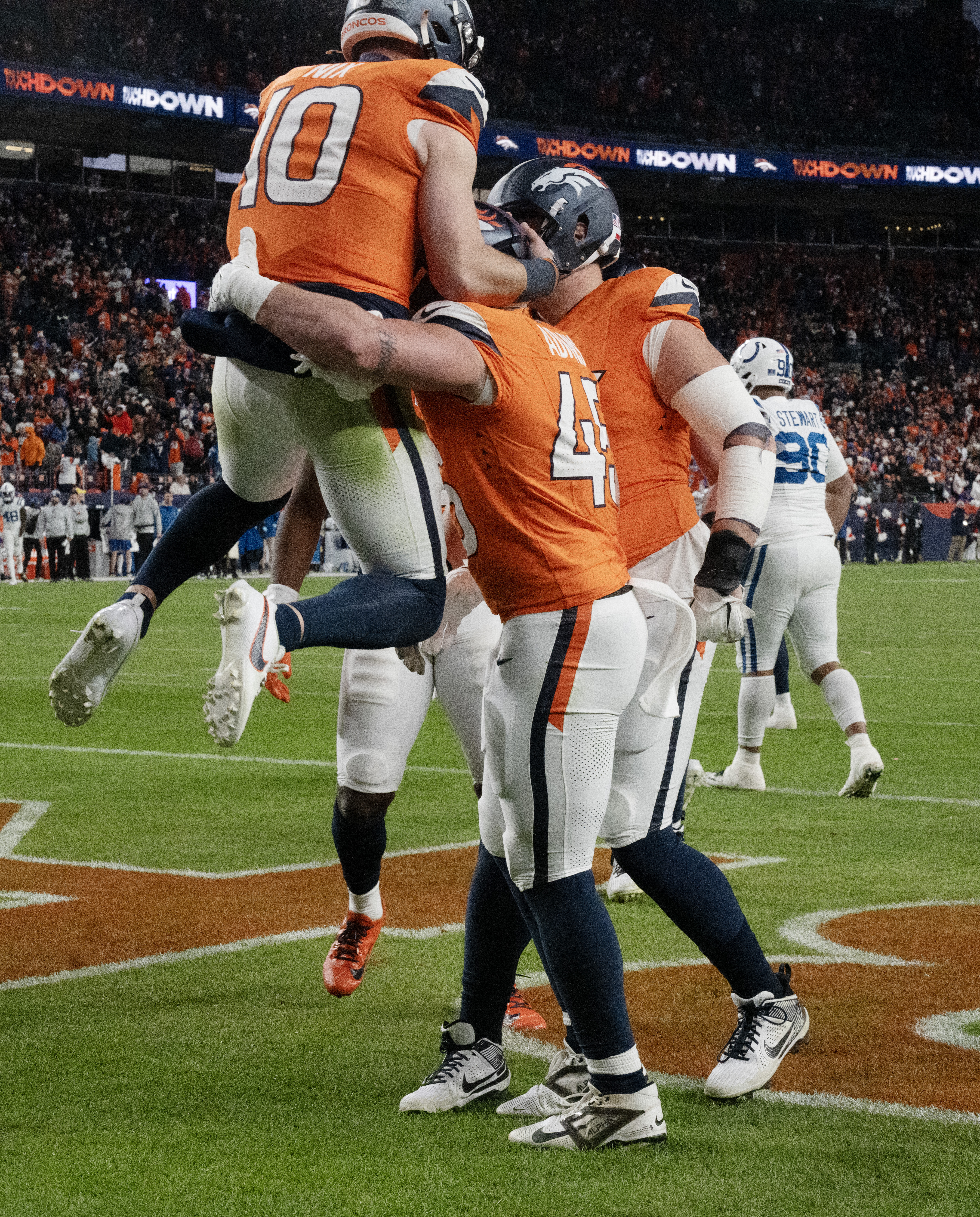 Denver Broncos quarterback Bo Nix (10) Denver Broncos tight end Nate Adkins (45) after a touchdown pass during a game against the Colts. The Broncos defeated the Colts 31-13 at Empower Field at Mile High on Sunday, Dec. 15, 2024. (Jerilee Bennett)