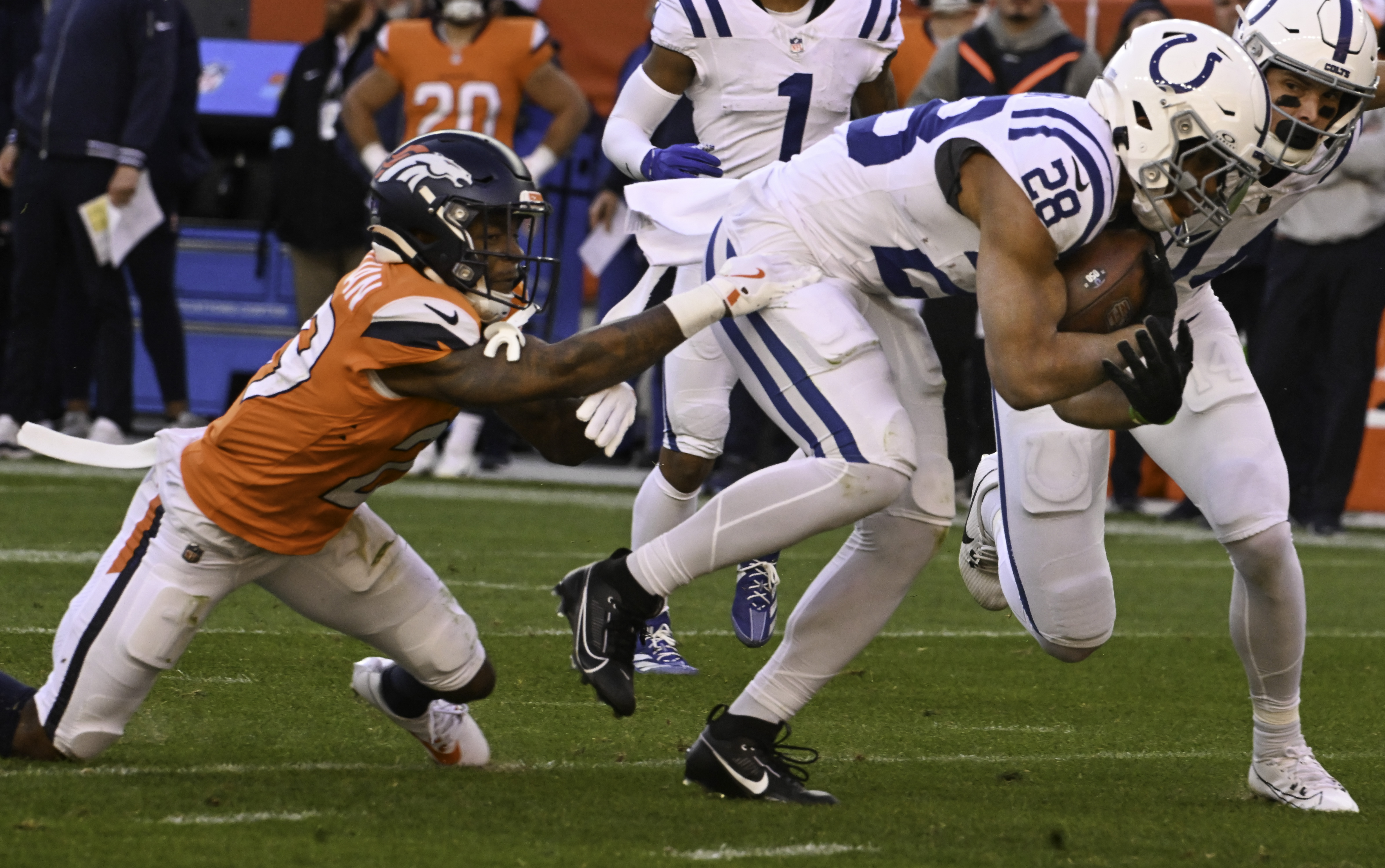 Denver Broncos cornerback Ja'Quan McMillian (29) defends Indianapolis Colts running back Jonathan Taylor (28) during a game. The Broncos defeated the Colts 31-13 at Empower Field at Mile High on Sunday, Dec. 15, 2024. (Jerilee Bennett, The Gazette)