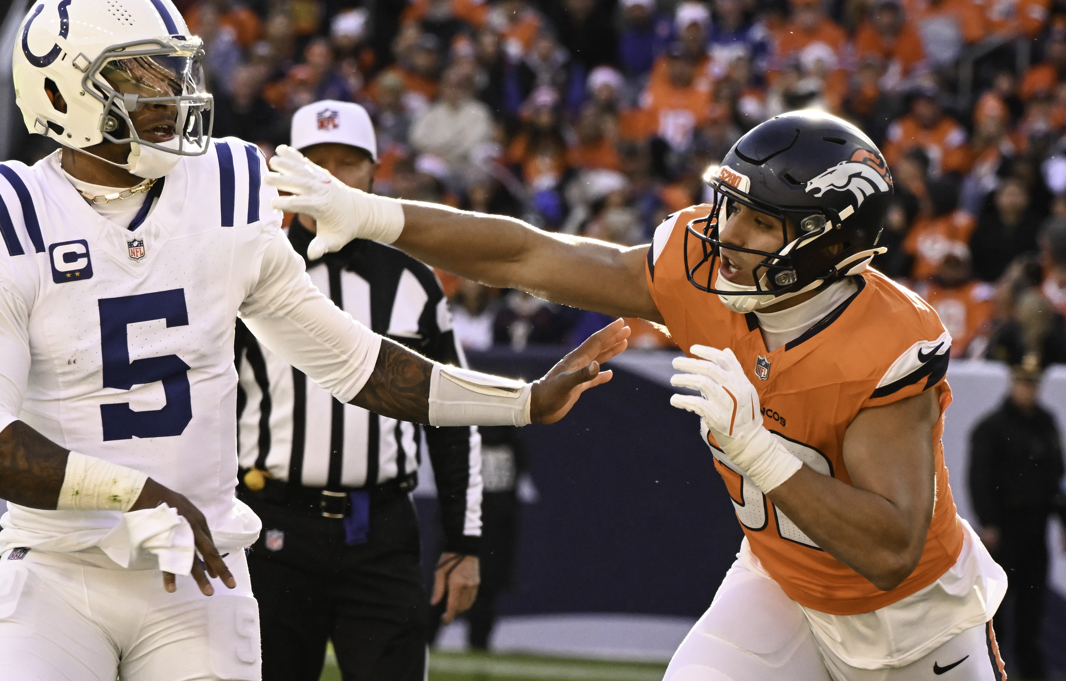 Denver Broncos linebacker Jonah Elliss (52) defends Indianapolis Colts quarterback Anthony Richardson (5) during a game. The Broncos defeated the Colts 31-13 at Empower Field at Mile High on Sunday, Dec. 15, 2024. (Jerilee Bennett,The Gazette)