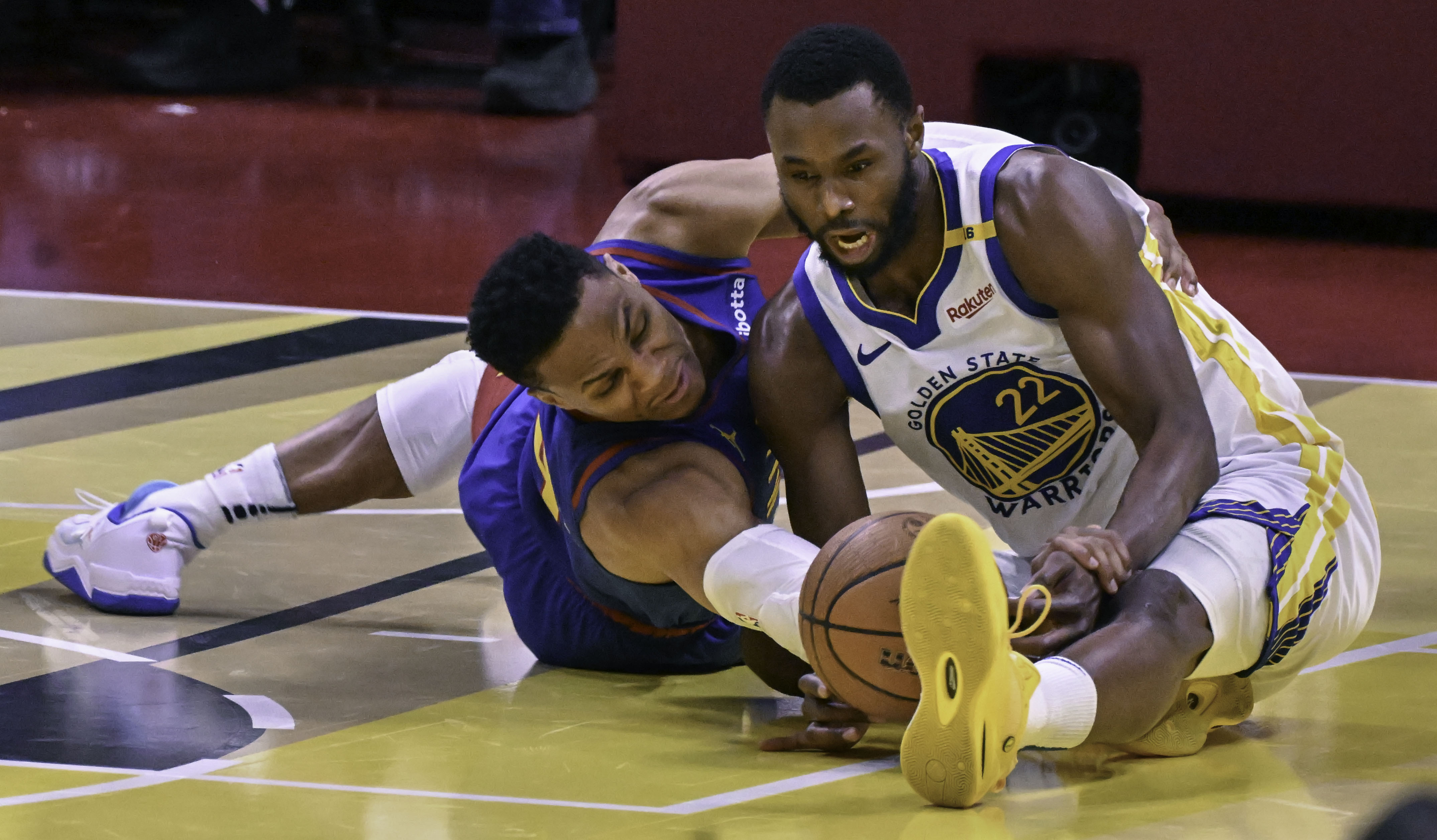 Denver Nuggets guard Russell Westbrook (4) fights for the ball with Golden State Warriors forward Andrew Wiggins (22) during an Emirates NBA Cup Group Play game at Ball Arena on Tuesday, Dec. 3, 2024. The Nuggets defeated the Warriors 119-115. (Jerilee Bennett,The Gazette)