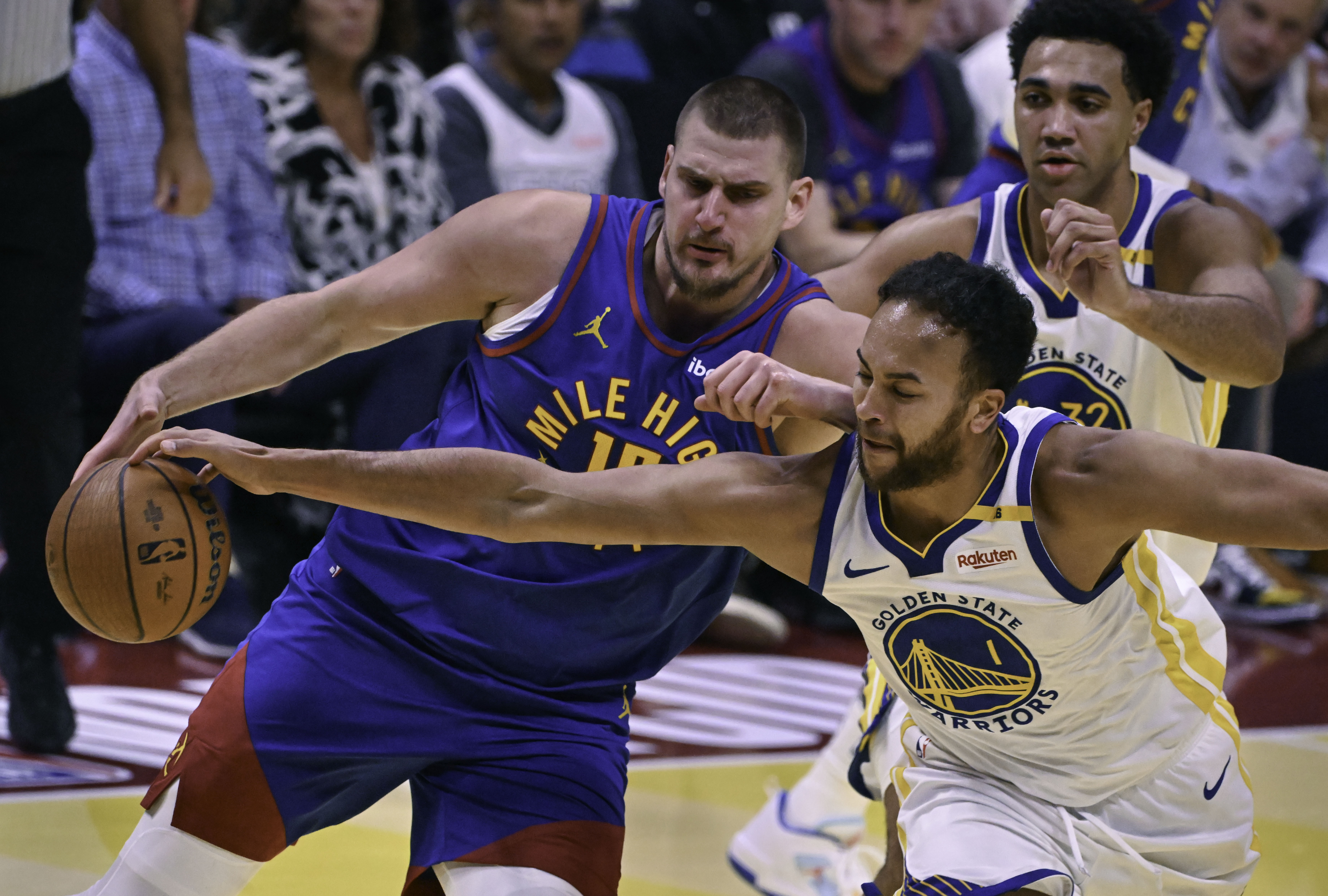 Golden State Warriors forward Kyle Anderson (1) tries to steal the ball from Denver Nuggets center Nikola Jokic (15) during an Emirates NBA Cup Group Play game at Ball Arena on Tuesday, Dec. 3, 2024. The Nuggets defeated the Warriors 119-115. (Jerilee Bennett,The Gazette)