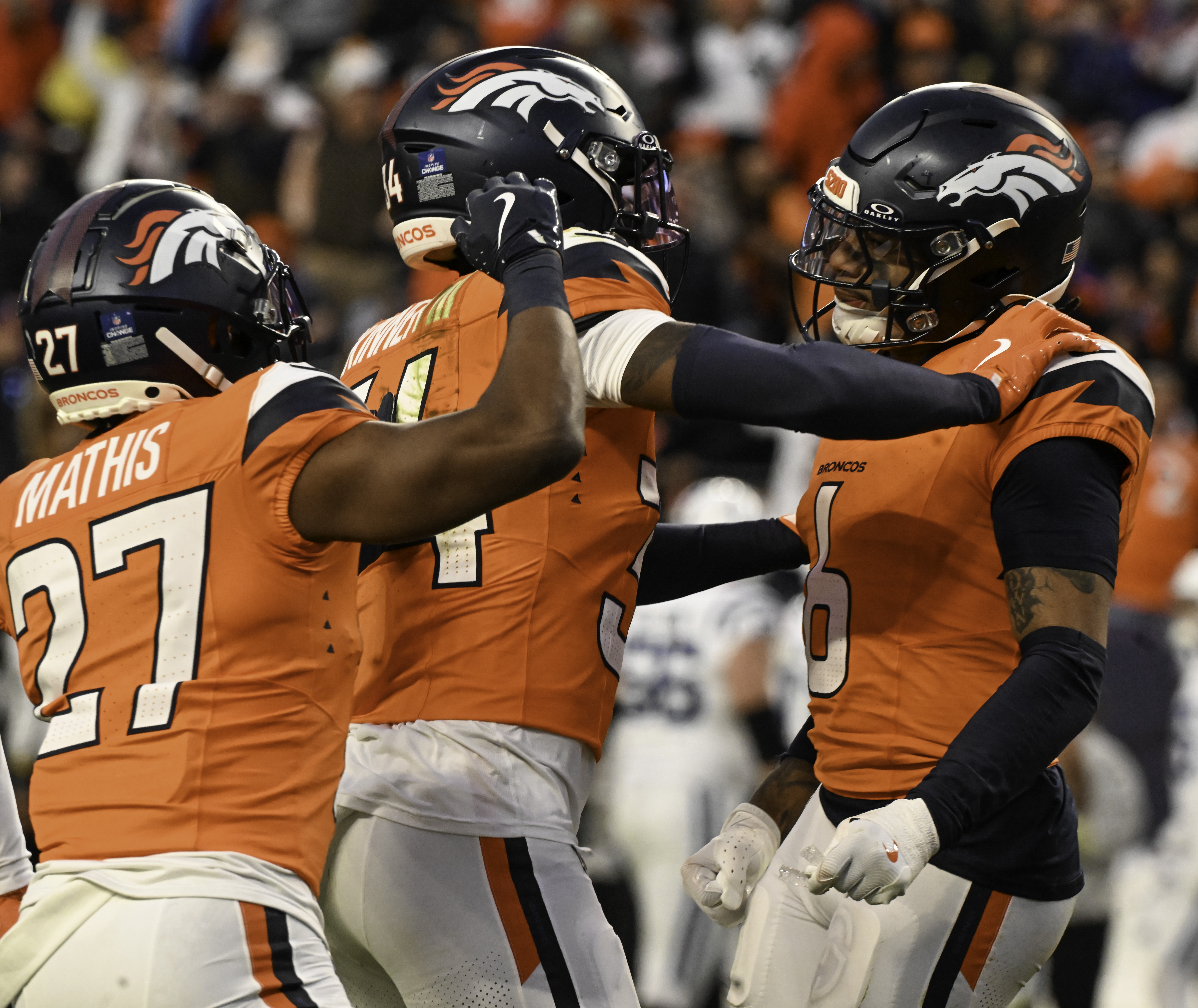 Denver Broncos safety P.J. Locke (6) (right) is congratulated byDenver Broncos cornerback Damarri Mathis (27) and Denver Broncos safety JL Skinner (34) causing a fumble during the second half of a game against the Colts.The Broncos defeated the Colts 31-13 at Empower Field at Mile High on Sunday, Dec. 15, 2024. (Jerilee Bennett,The Gazette)