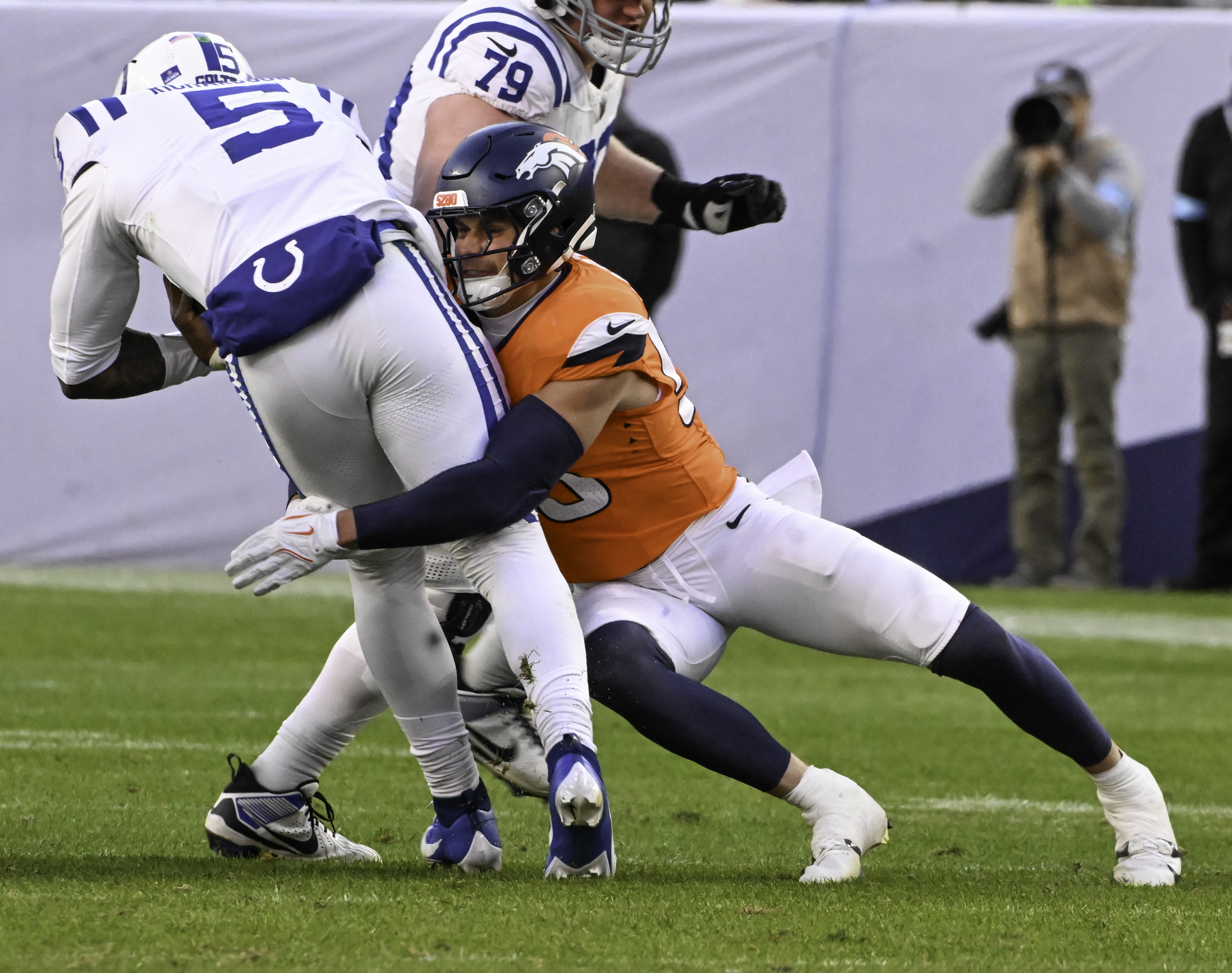 Denver Broncos linebacker Cody Barton (55) brings down Indianapolis Colts quarterback Anthony Richardson (5) during a game.. The Broncos defeated the Colts 31-13 at Empower Field at Mile High on Sunday, Dec. 15, 2024. (Jerilee Bennett,The Gazette)
