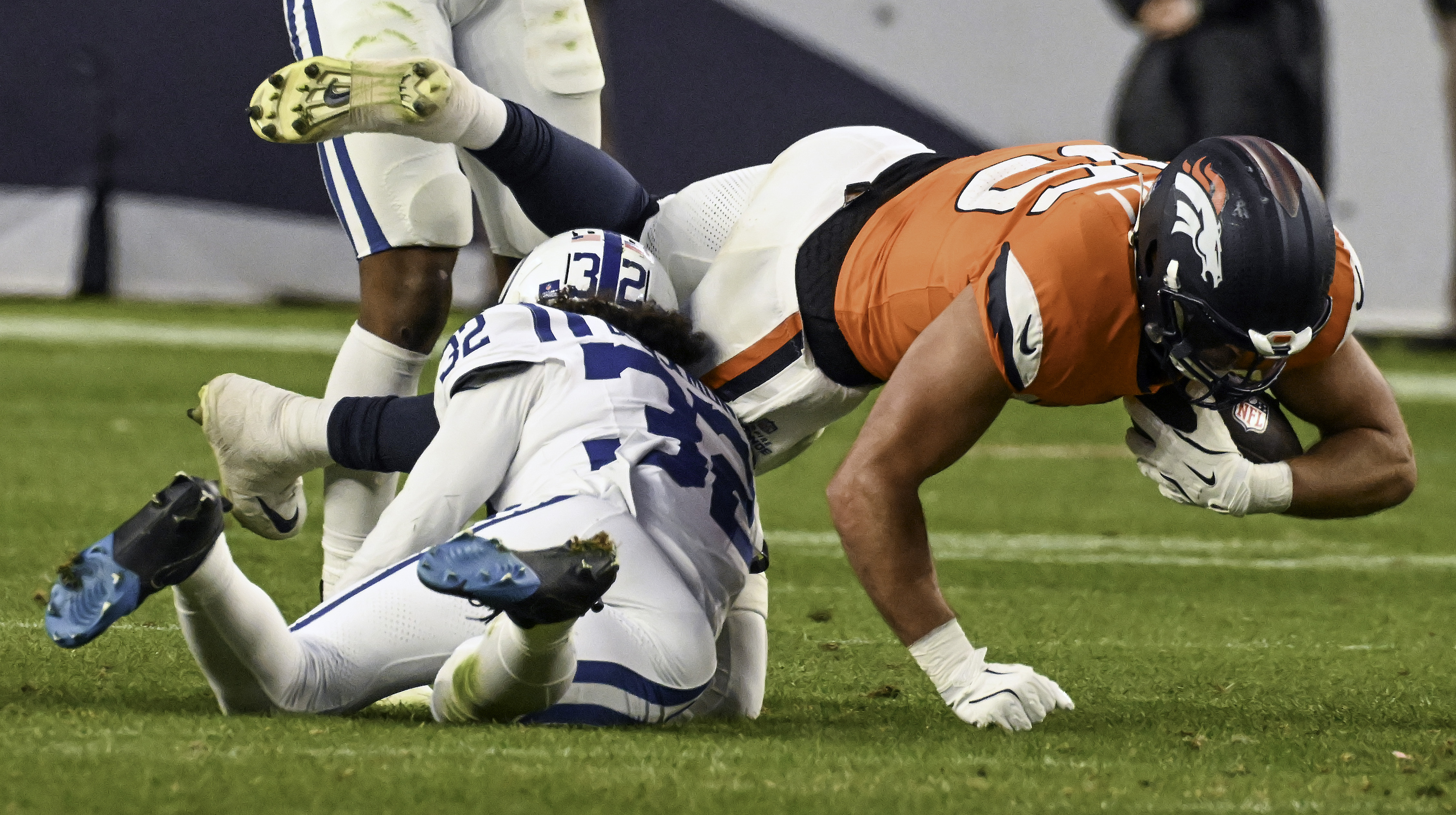 Denver Broncos tight end Lucas Krull (85) lunges forward for more yards after making a catch and getting tackled by Indianapolis Colts safety Julian Blackmon (32) during the second half of a game against the Colts.The Broncos defeated the Colts 31-13 at Empower Field at Mile High on Sunday, Dec. 15, 2024. (Jerilee Bennett,The Gazette)