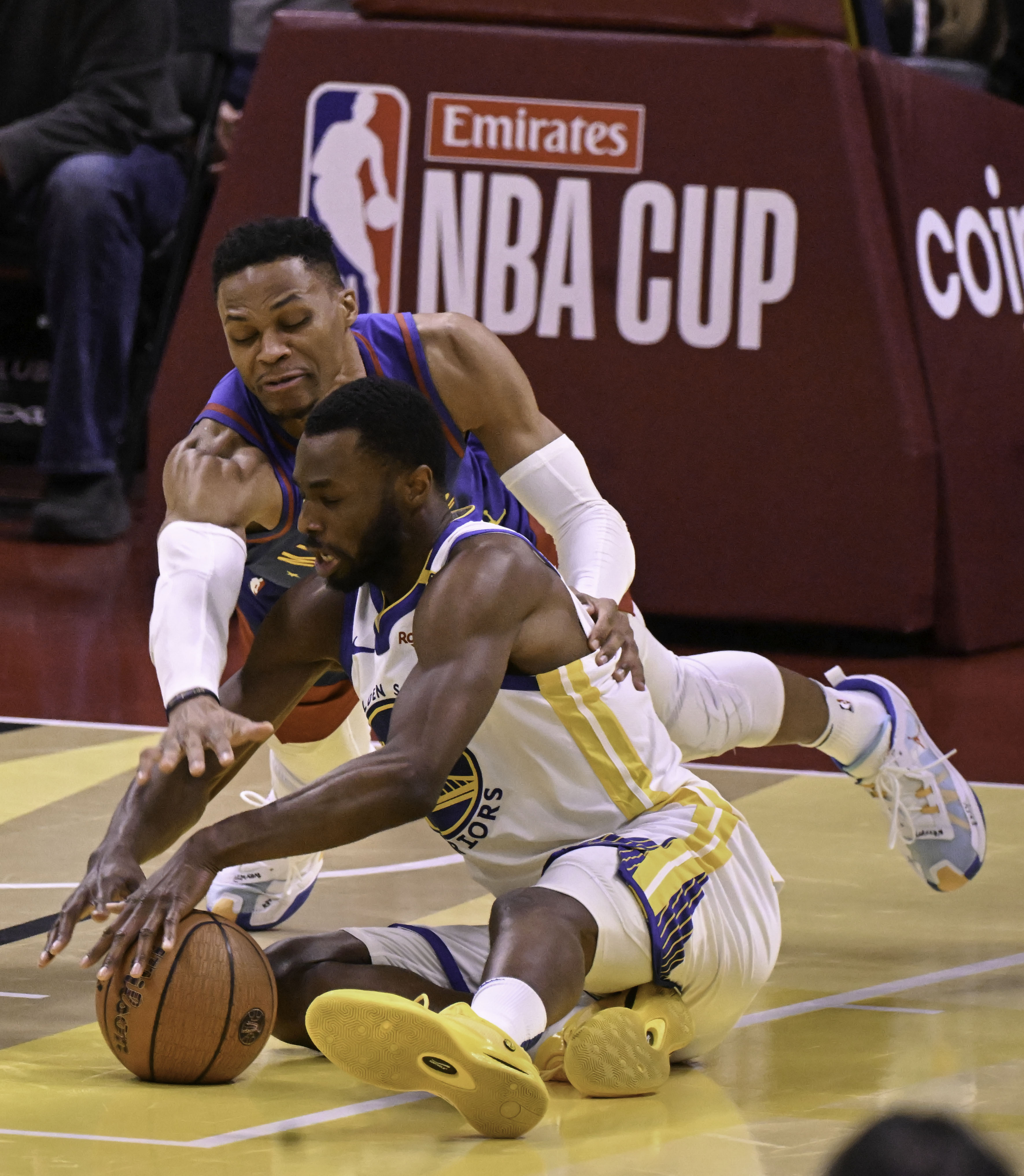 Denver Nuggets guard Russell Westbrook (4) scrambles for the ball with Golden State Warriors forward Andrew Wiggins (22) late in the fourth quarter of an Emirates NBA Cup Group Play game at Ball Arena on Tuesday, Dec. 3, 2024. (Jerilee Bennett,The Gazette)