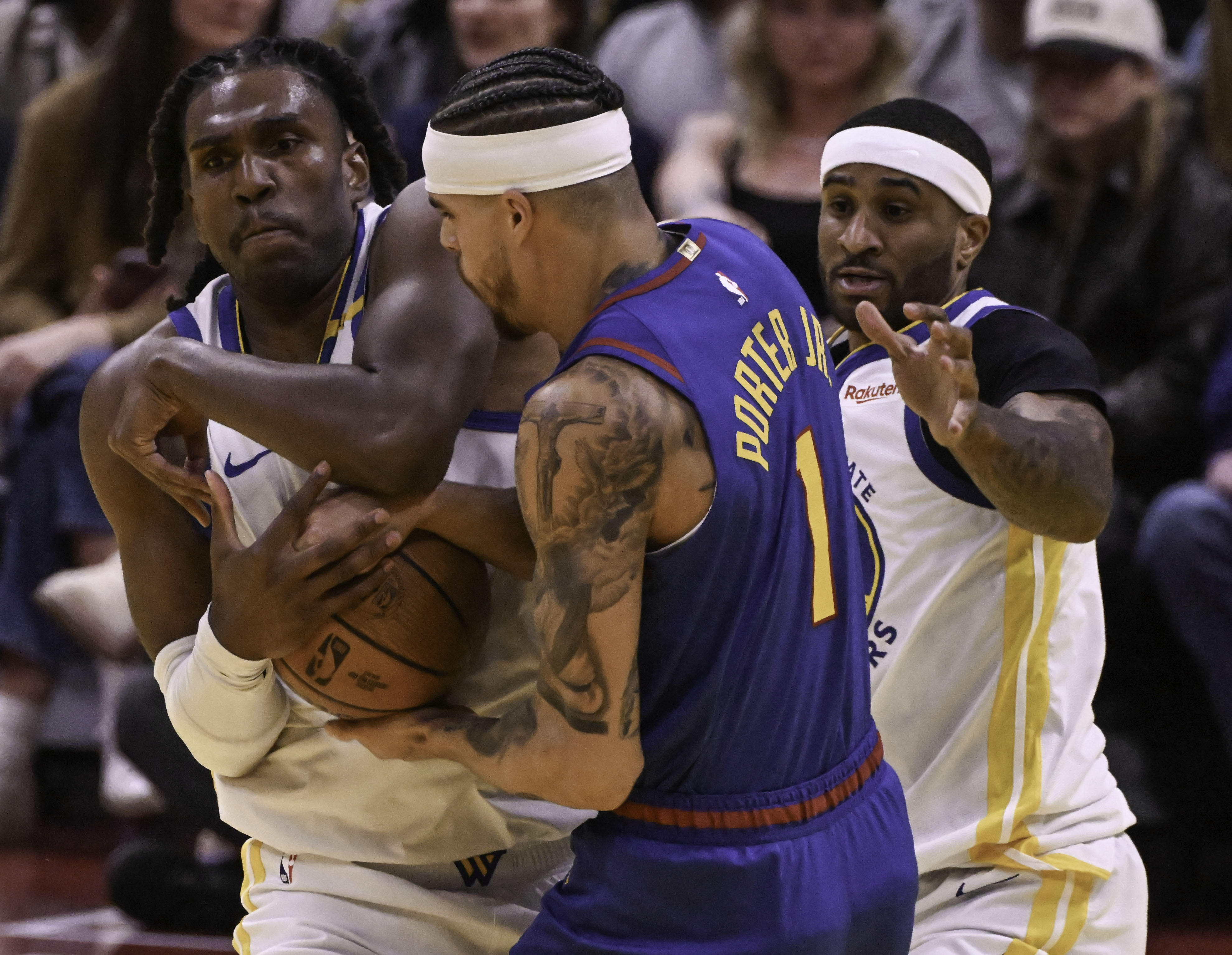 Denver Nuggets forward Michael Porter Jr. (1) tangles with Golden State Warriors forward Kevon Looney (5) during the second quarter for a jump ball during an Emirates NBA Cup Group Play game at Ball Arena on Tuesday, Dec. 3, 2024. (Jerilee Bennett,The Gazette)