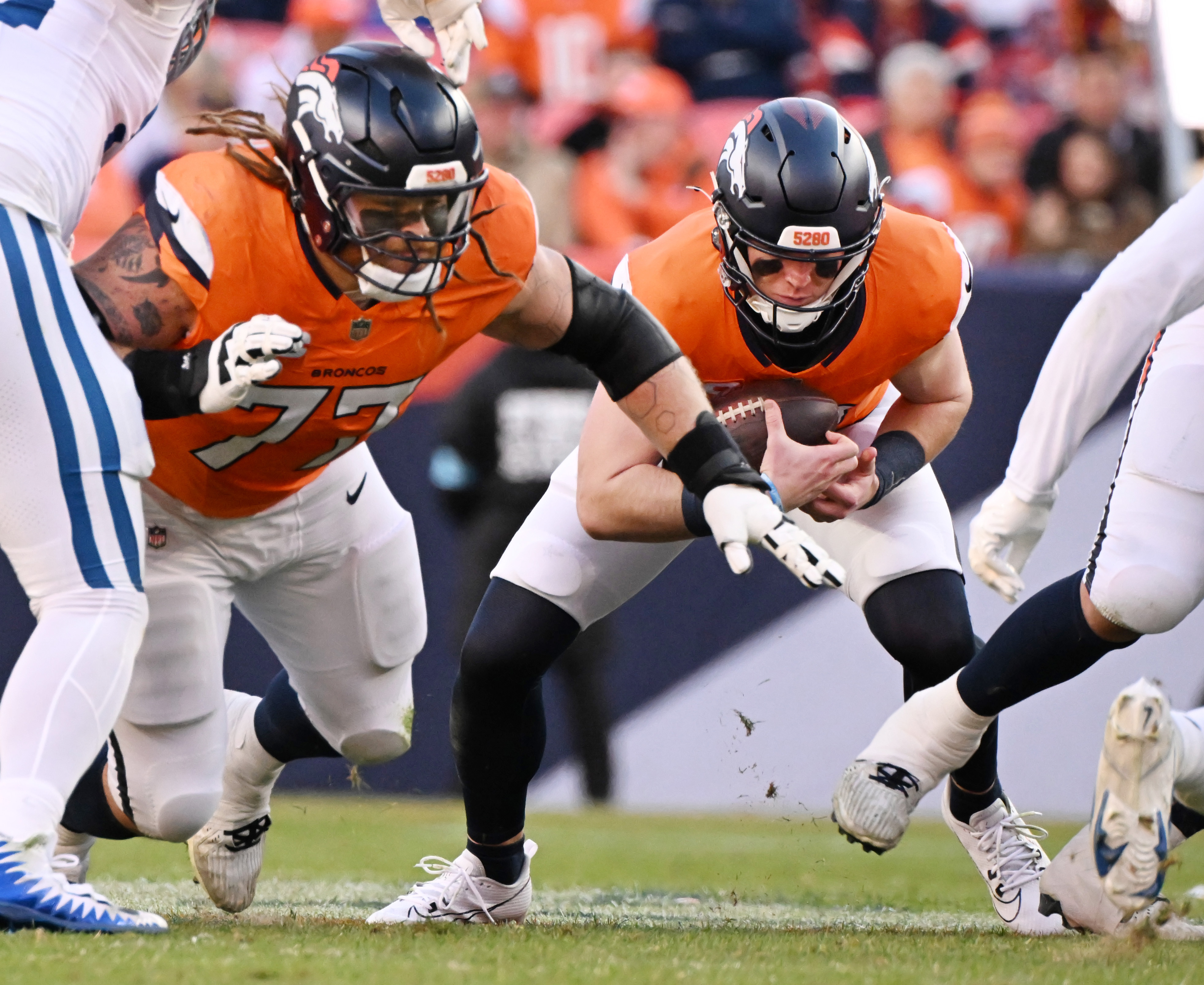 Denver Broncos quarterback Bo Nix (10) quarterback executes a successful quarterback sneak for a first down while being protected by Denver Broncos guard Quinn Meinerz (77) during the second quarter of a game against the Colts on Sunday, Dec. 15, 2024. (Jerilee Bennett, The Gazette)
