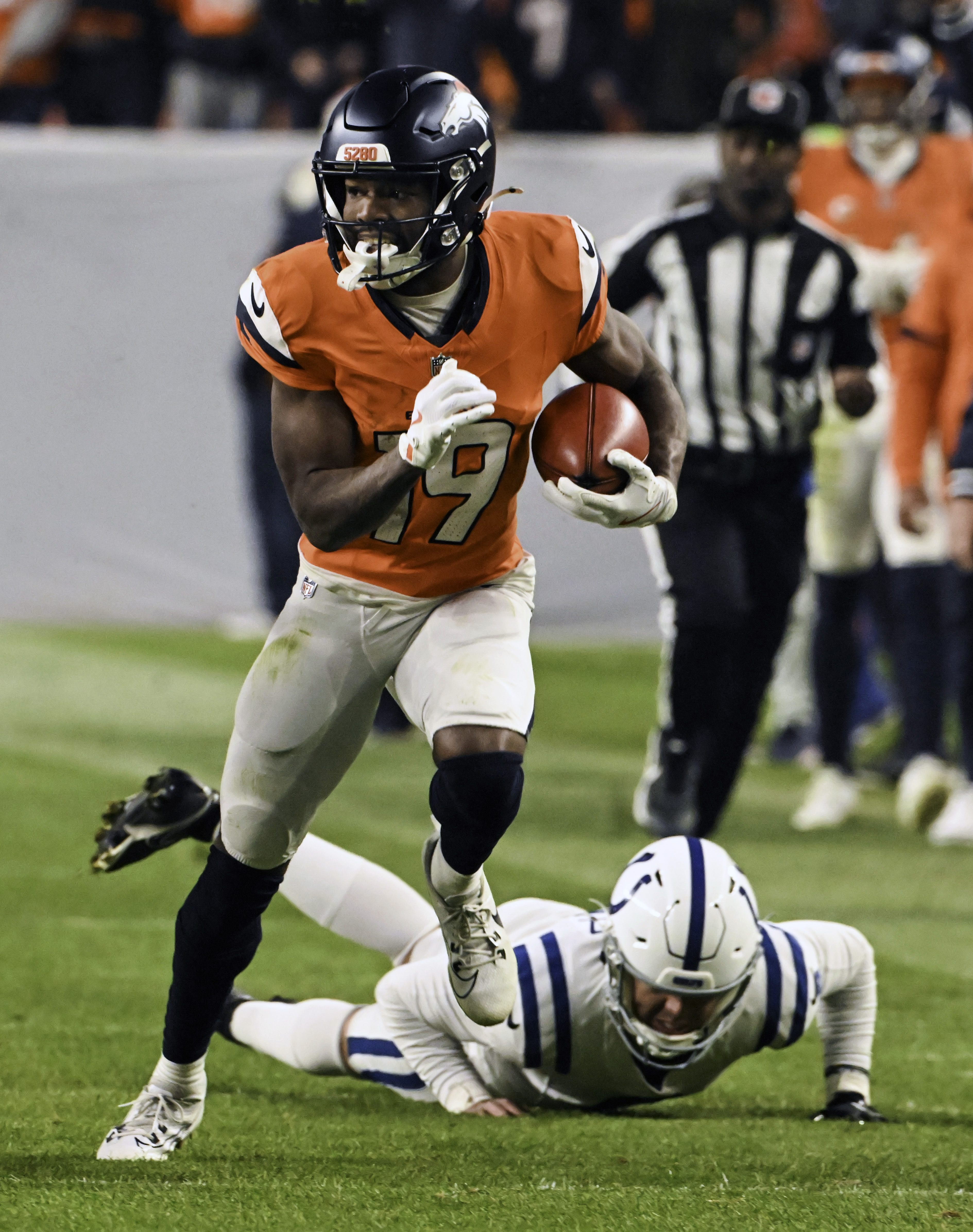 Denver Broncos wide receiver Marvin Mims Jr. (19) leaves Indianapolis Colts punter Rigoberto Sanchez (8) in the dust while he is returning a punt for 70 yards during the second half of a game against the Colts.The Broncos defeated the Colts 31-13 at Empower Field at Mile High on Sunday, Dec. 15, 2024. (Jerilee Bennett,The Gazette)