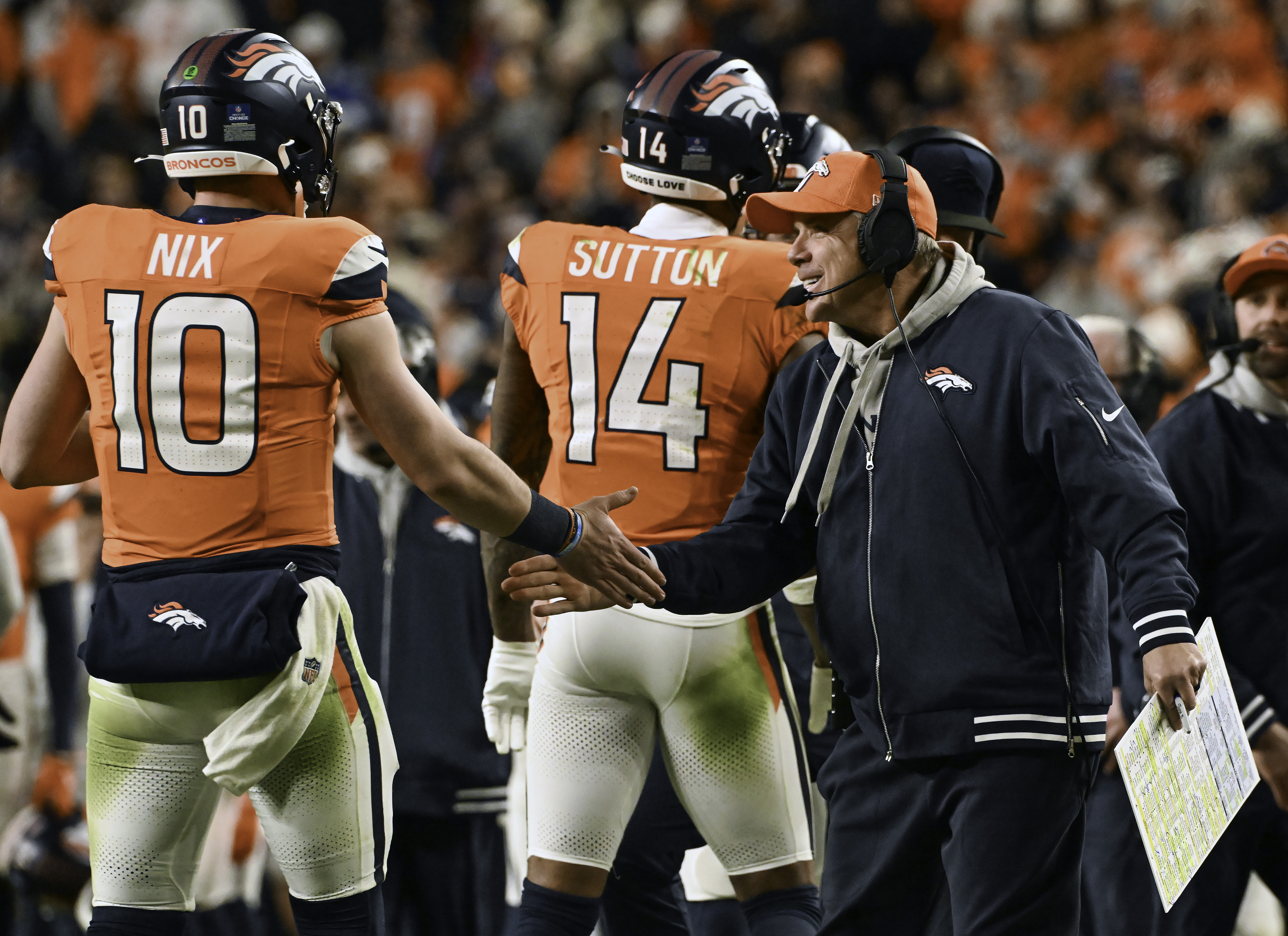 Denver Broncos Head Coach Sean Payton is all smiles for Denver Broncos quarterback Bo Nix (10) after Nix threw a touchdown pass the second half of a game against the Colts.  The Broncos defeated the Colts 31-13 at Empower Field at Mile High on Sunday, Dec. 15, 2024. (Jerilee Bennett,The Gazette)