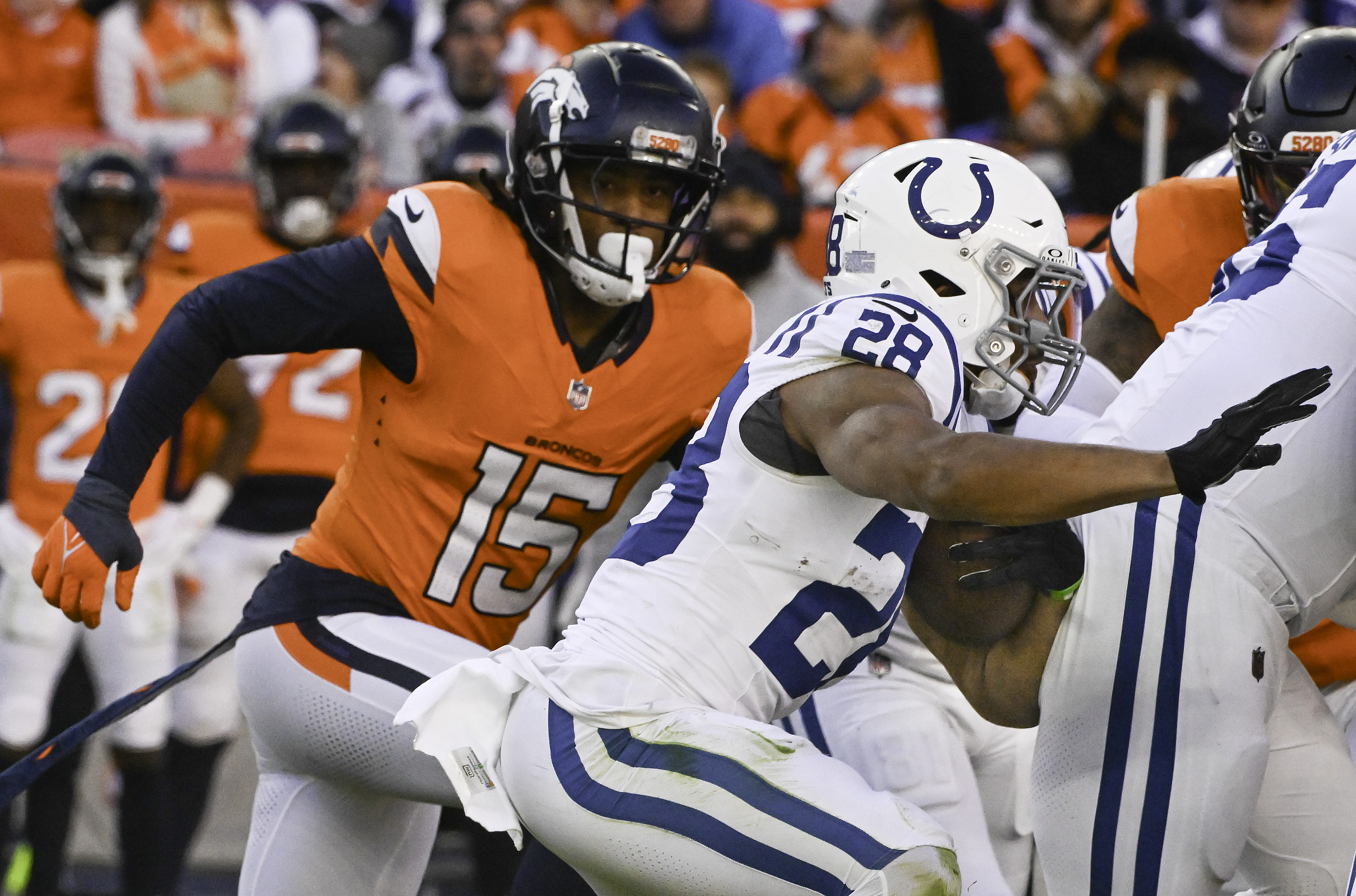 Denver Broncos linebacker Nik Bonitto (15) goes after Indianapolis Colts running back Jonathan Taylor (28) during a game. The Broncos defeated the Colts 31-13 at Empower Field at Mile High on Sunday, Dec. 15, 2024. (Jerilee Bennett,The Gazette)