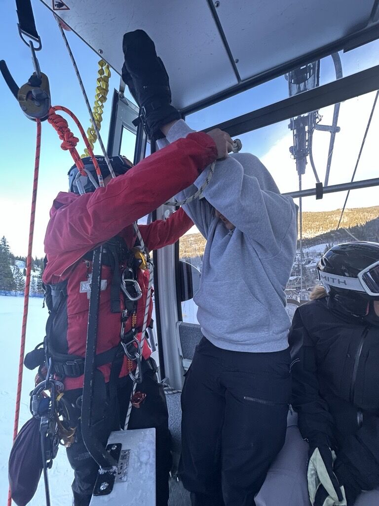 A Winter Park Resort ski patroller helps assist a person in rappelling from a gondola cabin after a malfunction on Dec. 21, 2024. (Courtesy photo, Jack Bronchetti)