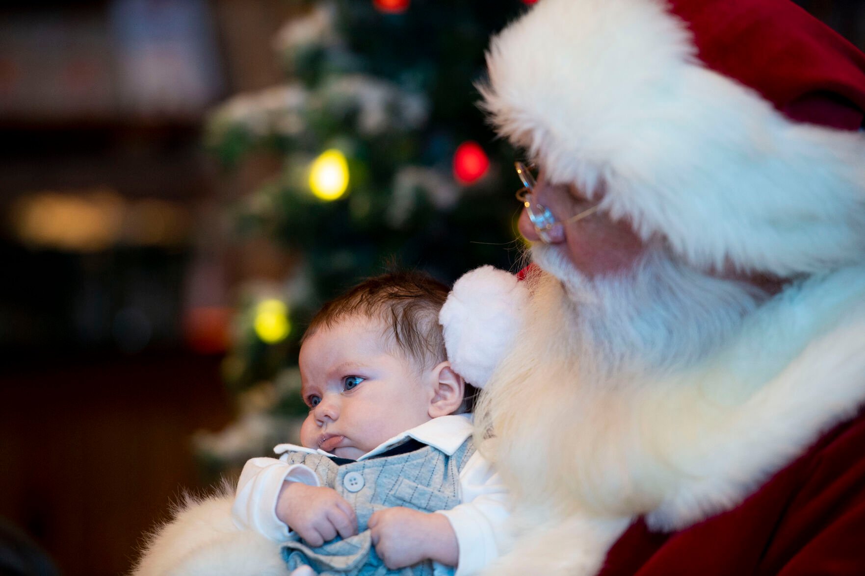 Santa Claus holds three-month-old Jameson Ford at the annual Santa's Wonderland at Bass Pro Shops in north Colorado Springs on Thursday, Nov. 25, 2021. (Chancey Bush / The Gazette) (Chancey Bush/ The Gazette)