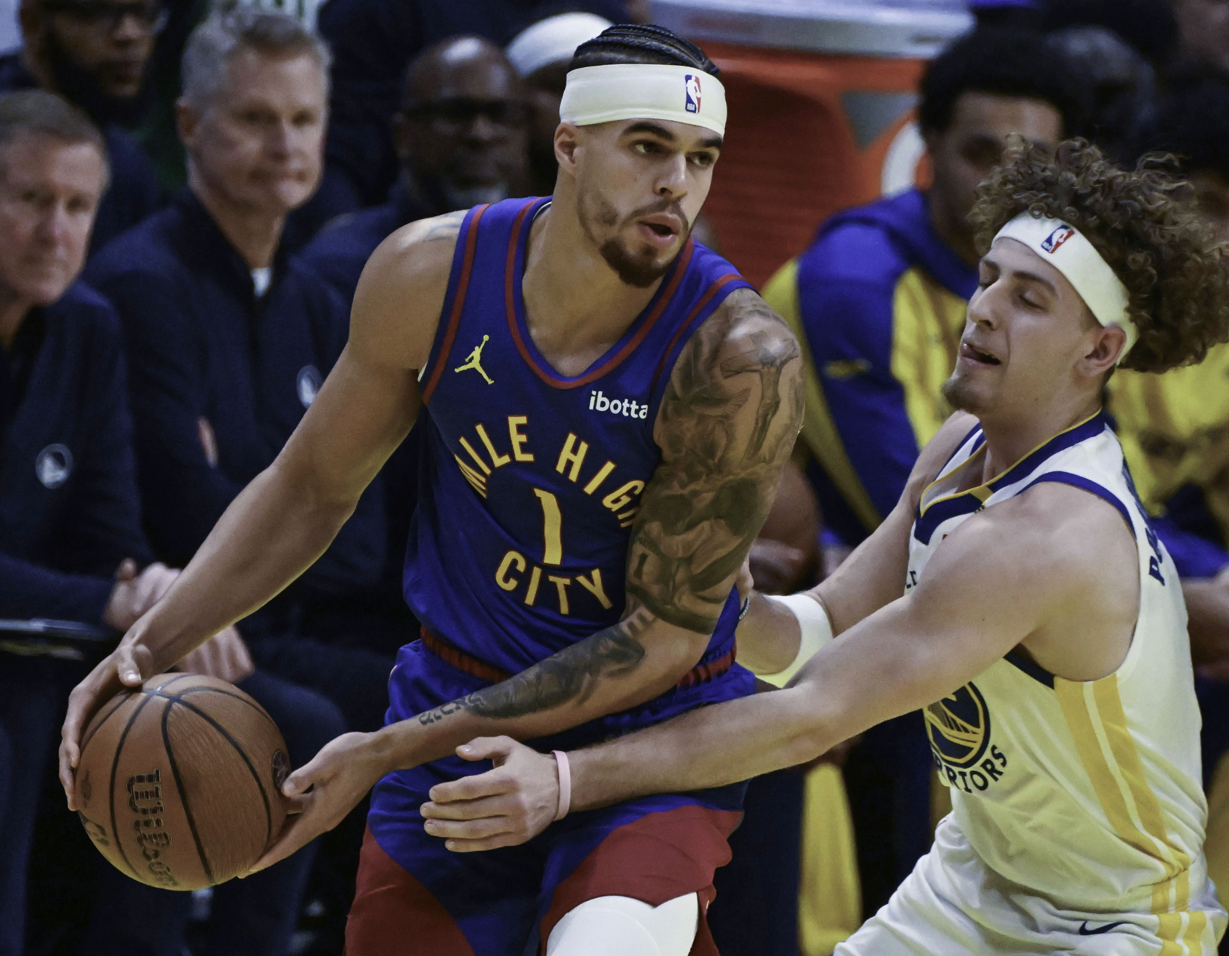 Denver Nuggets forward Michael Porter Jr. (1) is defended by Golden State Warriors guard Brandin Podziemski (2) during an Emirates NBA Cup Group Play game against the Warriors at Ball Arena on Tuesday, Dec. 3, 2024. The Nuggets defeated the Warriors 119-115. (Jerilee Bennett,The Gazette)