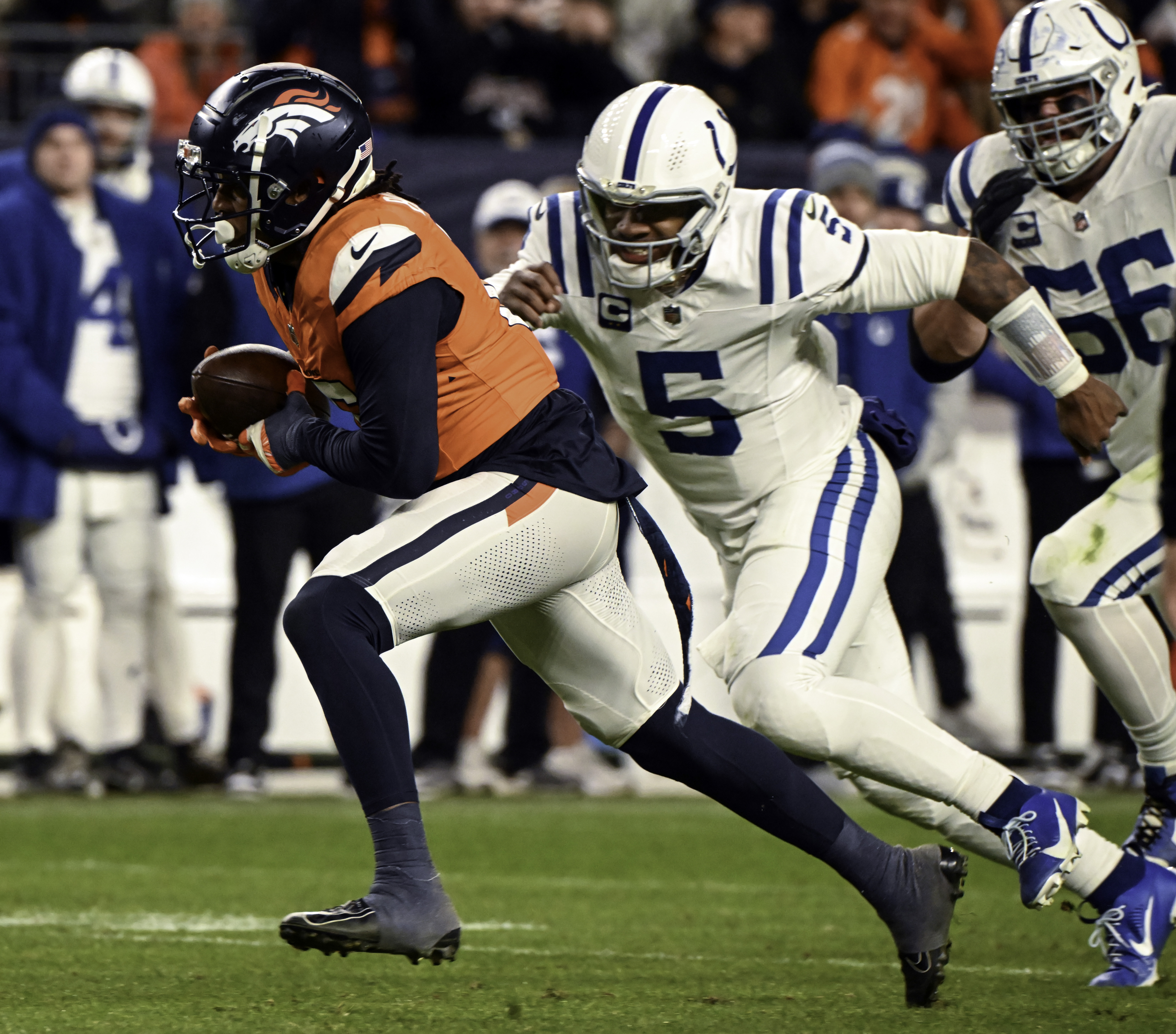 Denver Broncos linebacker Nik Bonitto (15) on fumble return is chased by Indianapolis Colts quarterback Anthony Richardson (5) during the second half of a game against the Colts. Bonitto scored a 50-yard touchdown on the fumlbe return. The Broncos defeated the Colts 31-13 at Empower Field at Mile High on Sunday, Dec. 15, 2024. (Jerilee Bennett,The Gazette)