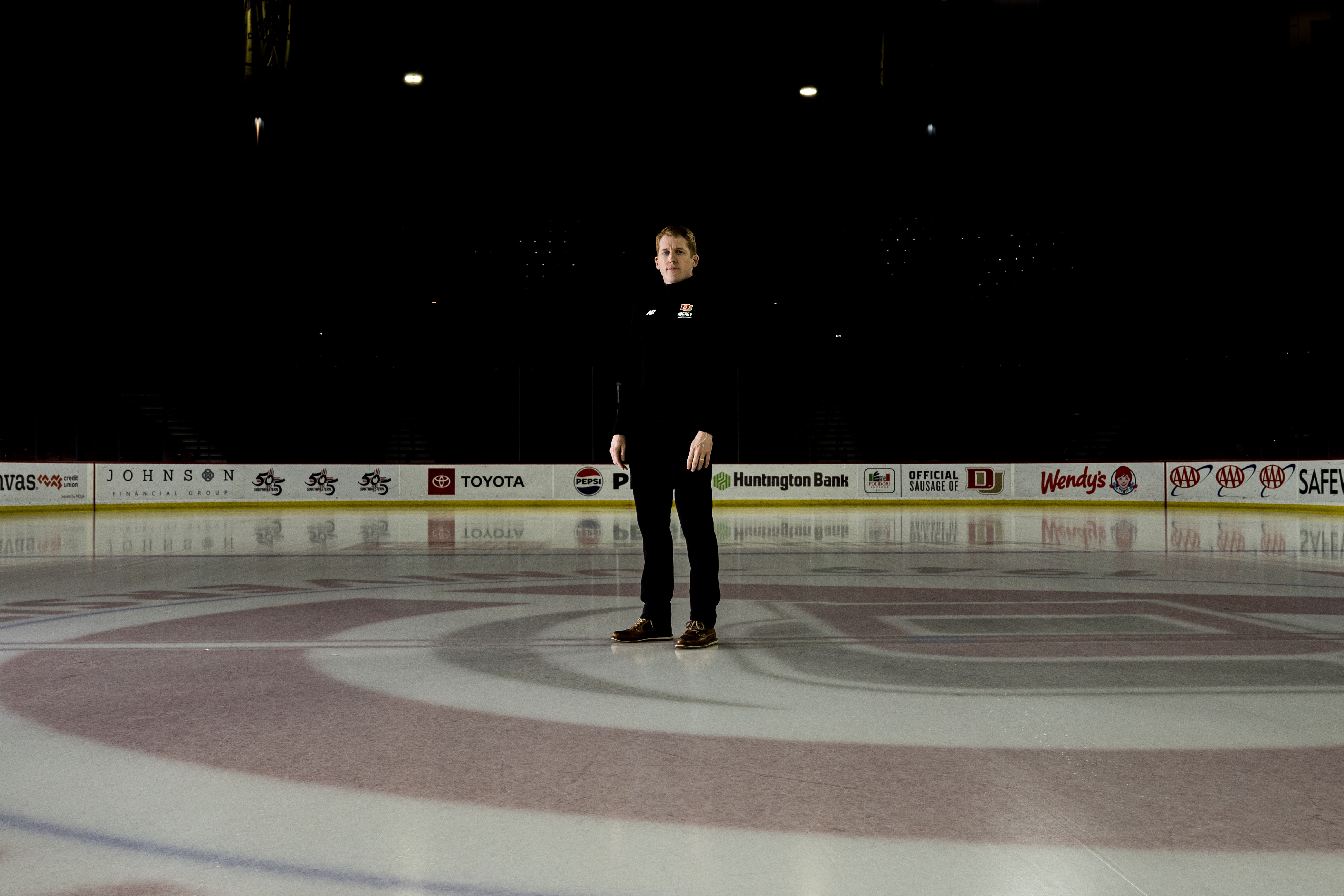 David Carle, head coach of Denver Pioneers hockey, poses for a portrait in Magness Arena on Tuesday, Dec. 10, 2024 (Stephen Swofford, Denver Gazette) (StephenSwoffordPhotographerstephen.swofford@gazette.comhttps://secure.gravatar.com/avatar/1ddcaf11c5d70eaa58546ddc4e038687?d=mm&r=g)