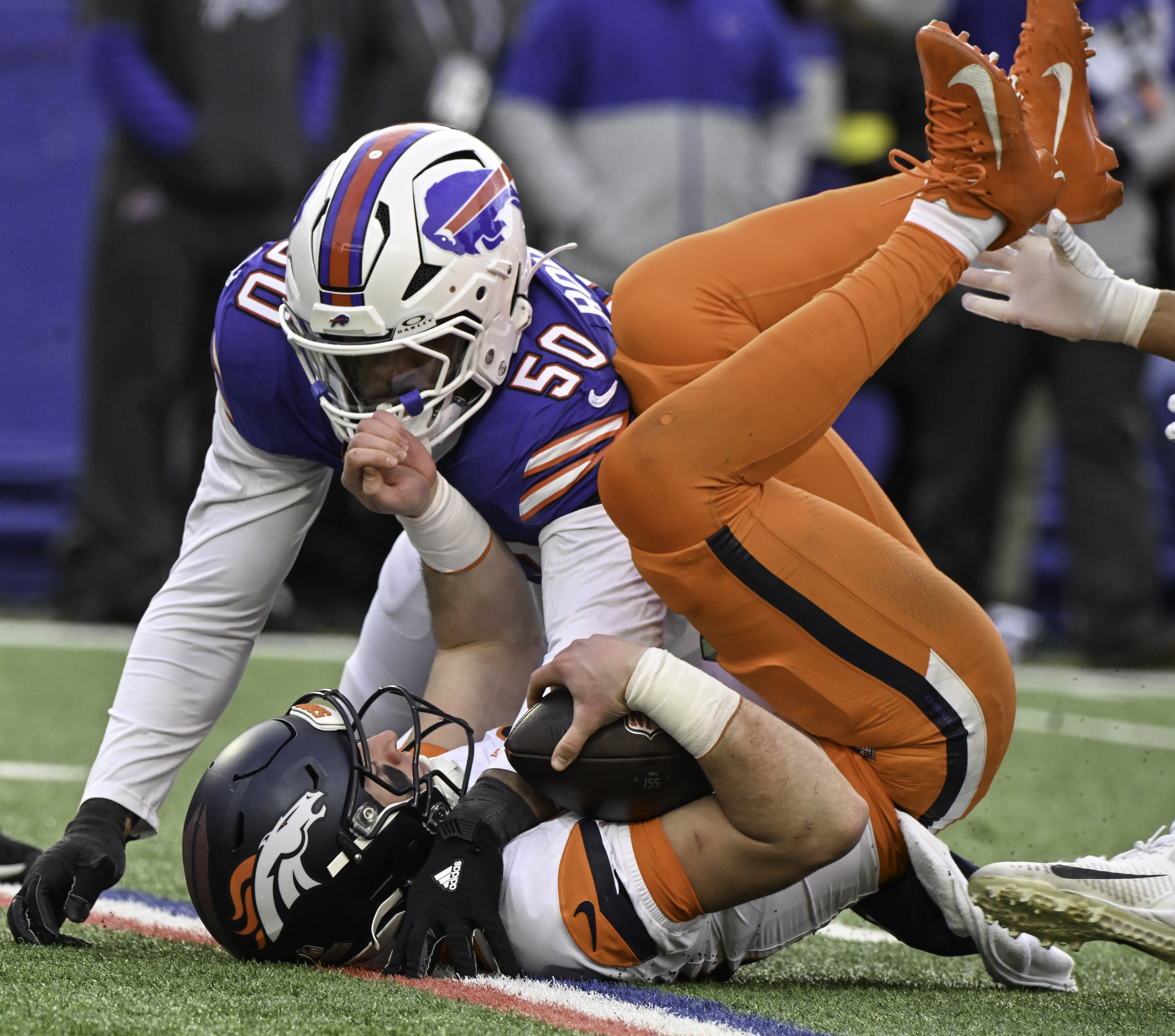 Denver Broncos quarterback Bo Nix (10) is sacked by Buffalo Bills defensive end Greg Rousseau (50) in the 4th quarter at Highmark Stadium in Buffalo on Sunday, Jan. 12, 2024. The Broncos lost the game 31-7. (Jerlee Bennett,The Gazette)