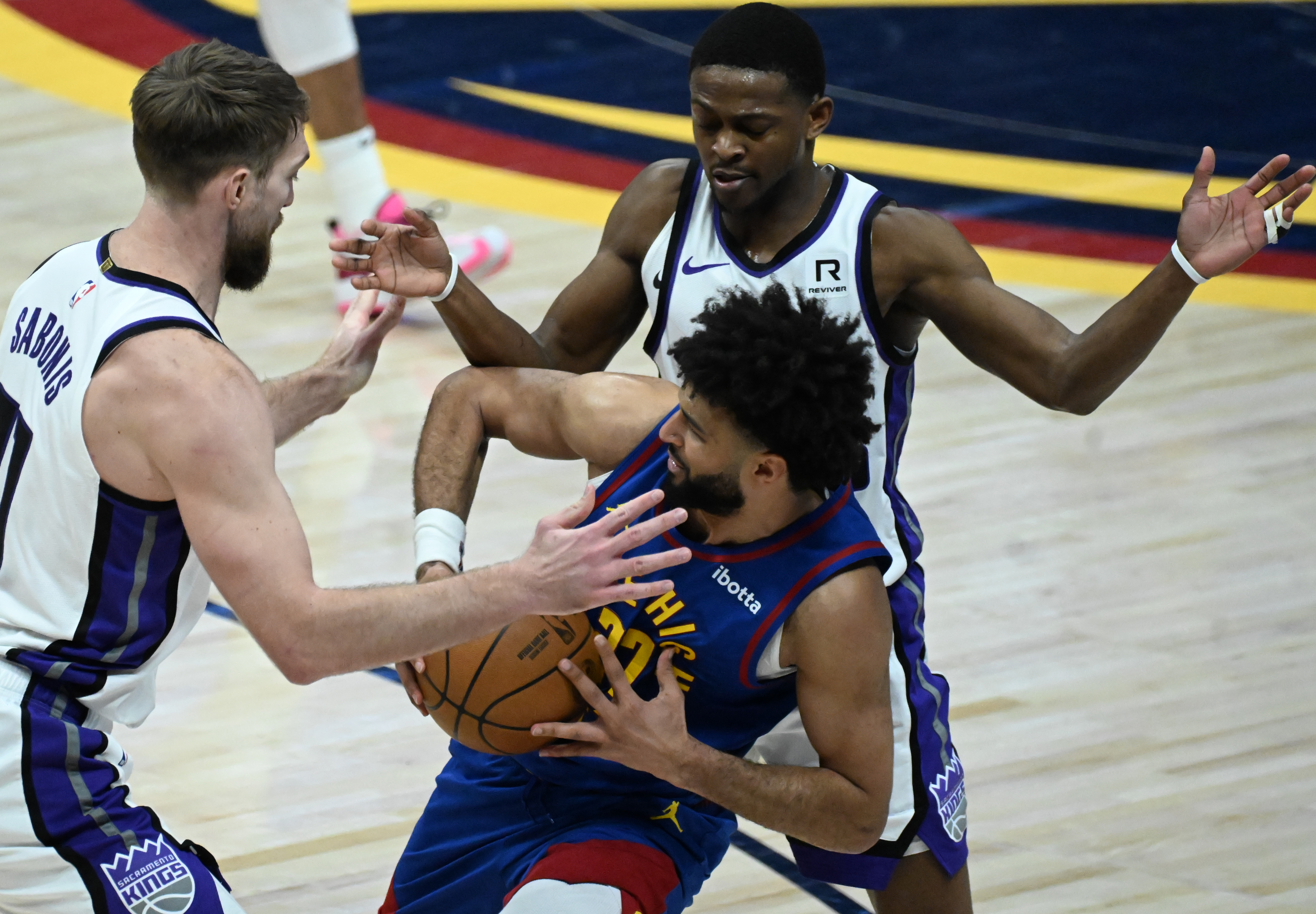 Denver Nuggets guard Jamal Murray (27) is pressured by Sacramento Kings forward Domantas Sabonis (11) during the 4th quarter of a game against the Kings at Ball Arena on Thursday, Jan. 23, 2025. (Jerilee Bennett,The Gazette)