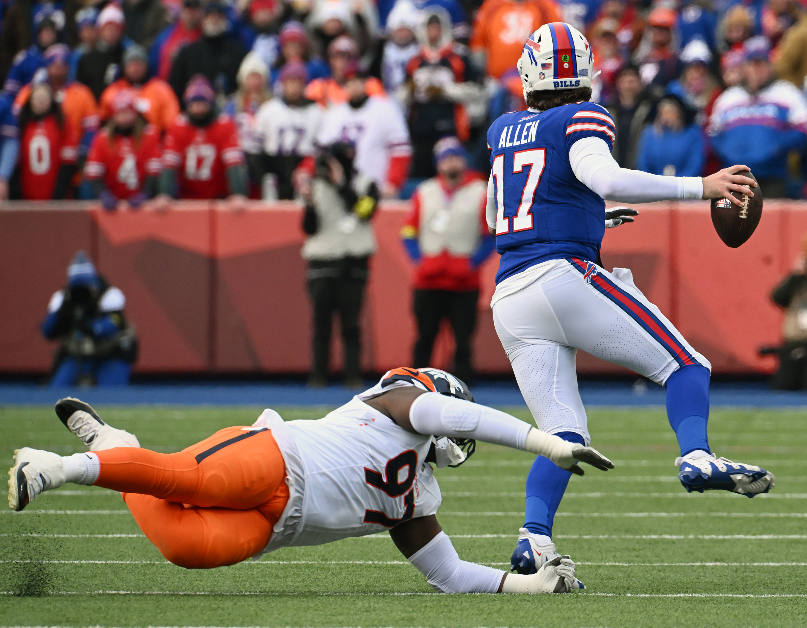 Denver Broncos defensive tackle Malcolm Roach (97) goes after Buffalo Bills quarterback Josh Allen (17) and misses during the wild card playoff game against the Bills in Buffalo on Sunday, January 12, 2024. The Broncos lost the game 31-7. (Jerilee Bennett, The Gazette)