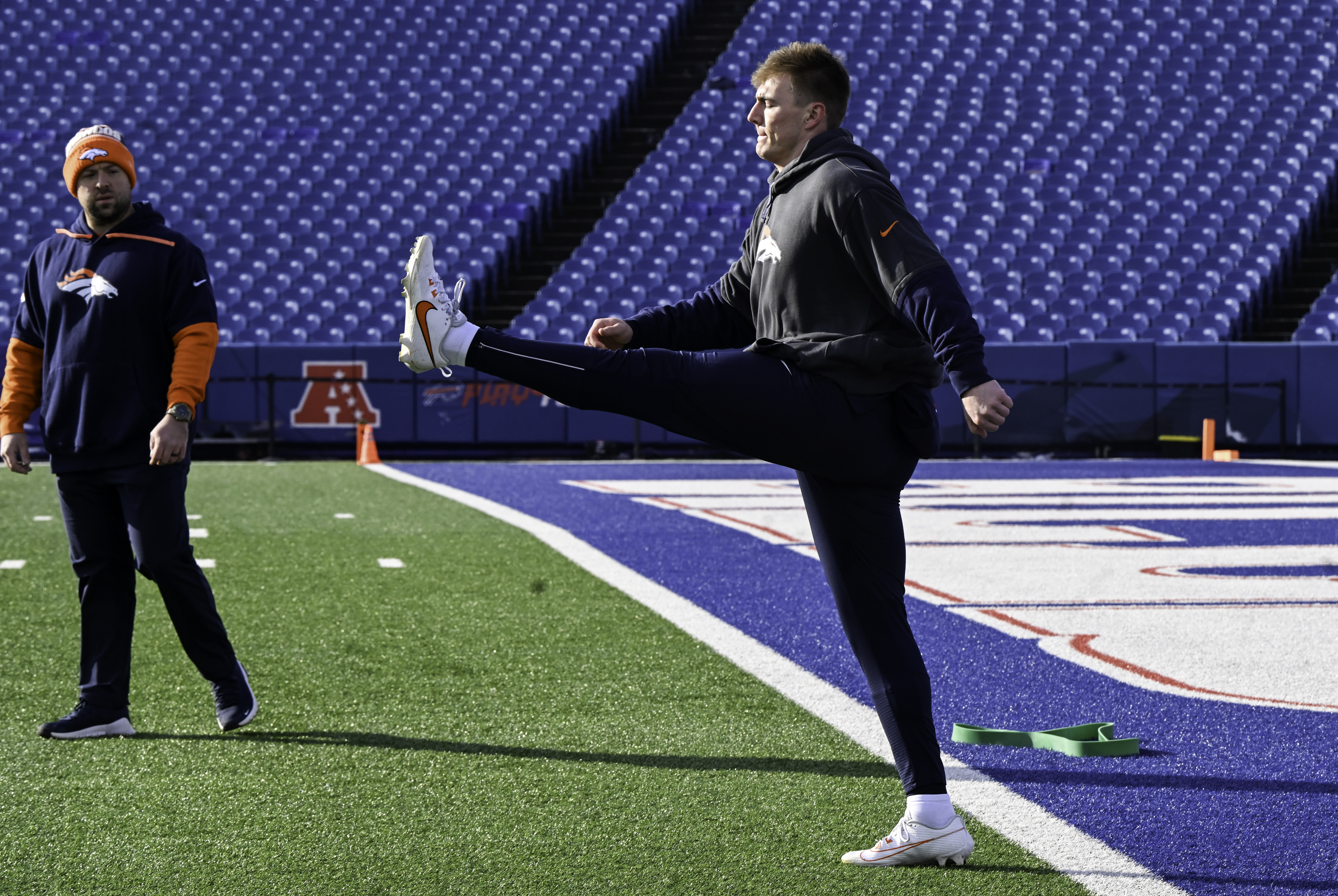Denver Broncos quarterback Bo Nix (10) warms up with Shaun Snee, Broncos strength and conditioning coach,. before the wild card playoff game between the Broncos and the Bills at Highmark Stadium in Buffalo on Sunday, January 12, 2025. (Jerilee Bennett,The Gazette)