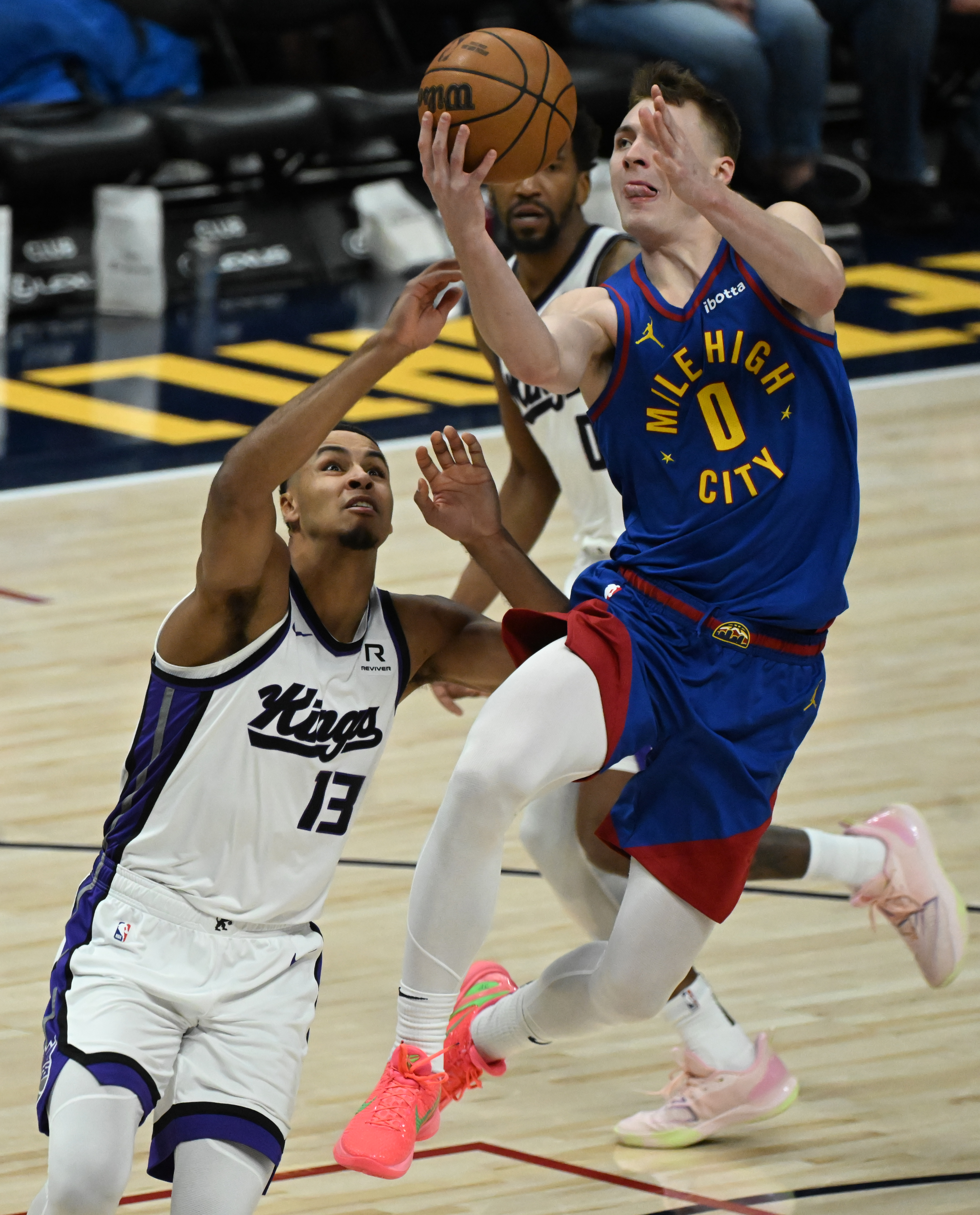 Denver Nuggets guard Christian Braun (0) goes up for a shot over Sacramento Kings forward Keegan Murray (13) during game at Ball Arena on Thursday, Jan. 23, 2025. The Nuggets defeated the Kings 132-123. (Jerilee Bennett,The Gazette)