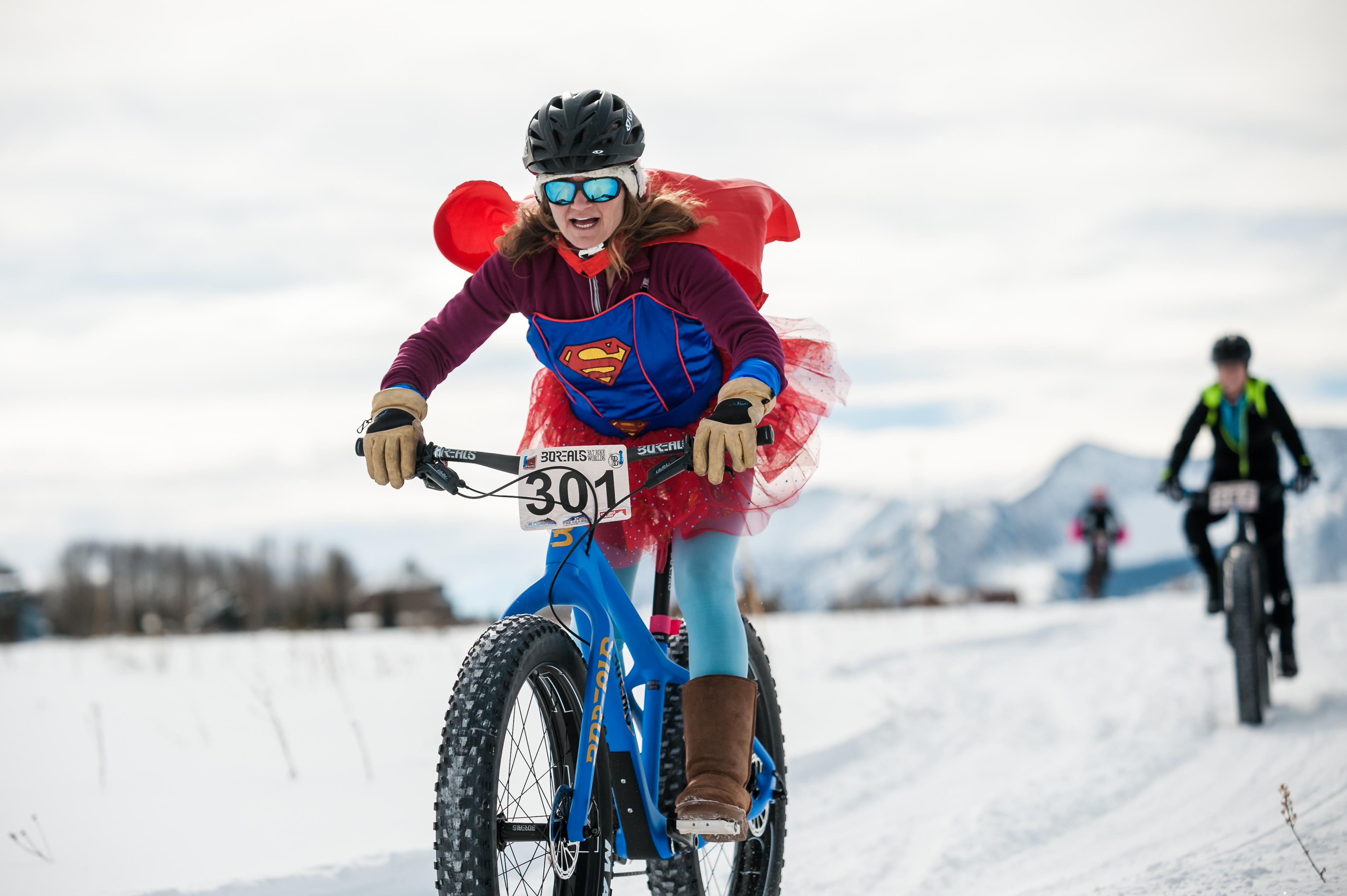 A fat biker in a Superwoman costume pedals her Fat Bike during a Fat Bike Worlds race in Crested Butte, Colorado. (Courtesy, Fat Bike Worlds)
