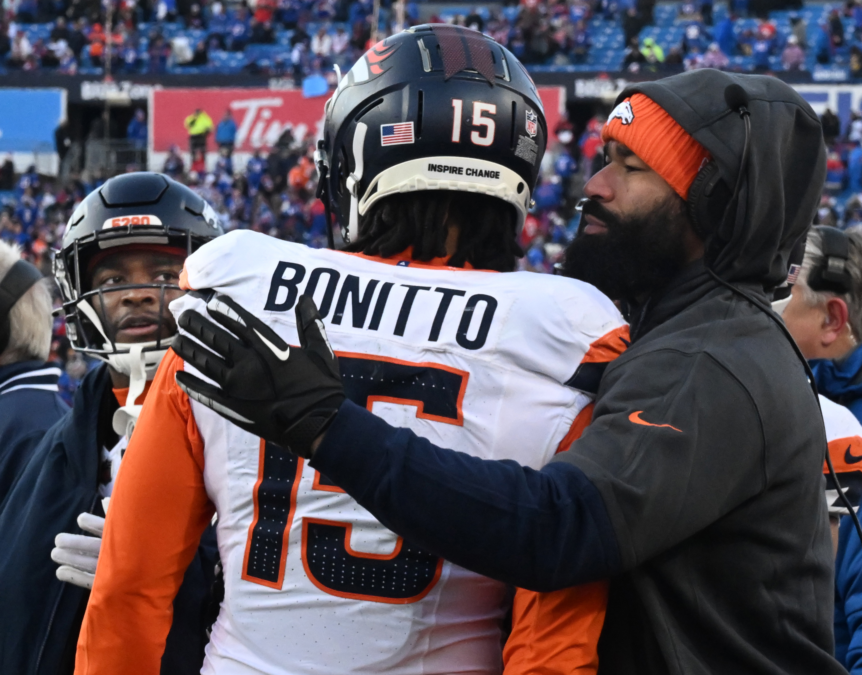 Denver Broncos linebacker Nik Bonitto (15) gets comforted in the final minutes of the wild card playoff game at Highmark Stadium in Buffalo on Sunday, Jan. 12, 2025. The Broncos lost 31-7. (Jerilee Bennett,The Gazette)