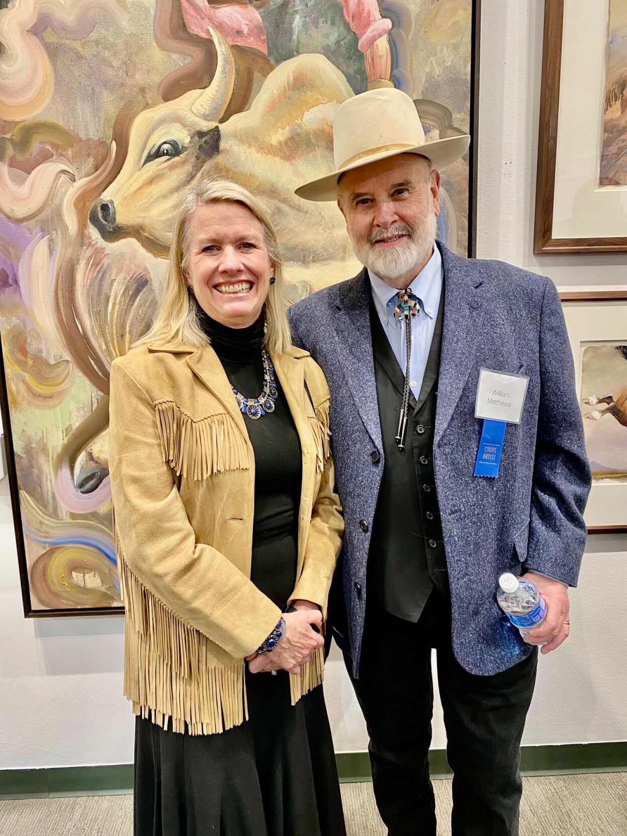 Laura Barton and husband William Matthews in front of his watercolor, Bull Flyer.jpg