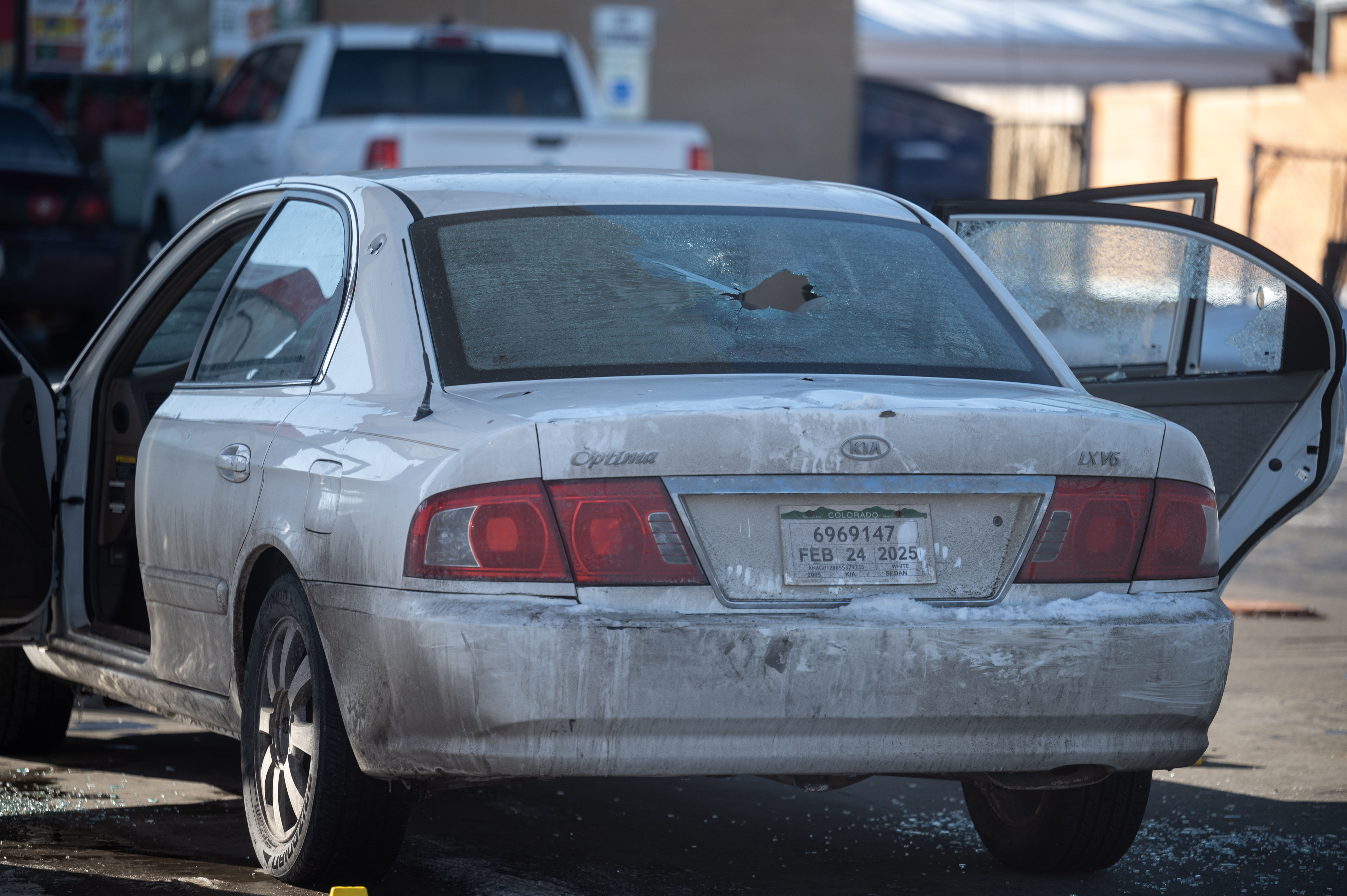 A car with bullet holes in the trunk and back windows sits in a gas station lot as Crime Scene Investigators examine the scene of a shooting on Colorado Blvd in Denver on Monday, Jan. 27, 2025. (Stephen Swofford, Denver Gazette) (StephenSwoffordPhotographerstephen.swofford@gazette.comhttps://secure.gravatar.com/avatar/1ddcaf11c5d70eaa58546ddc4e038687?d=mm&r=g)