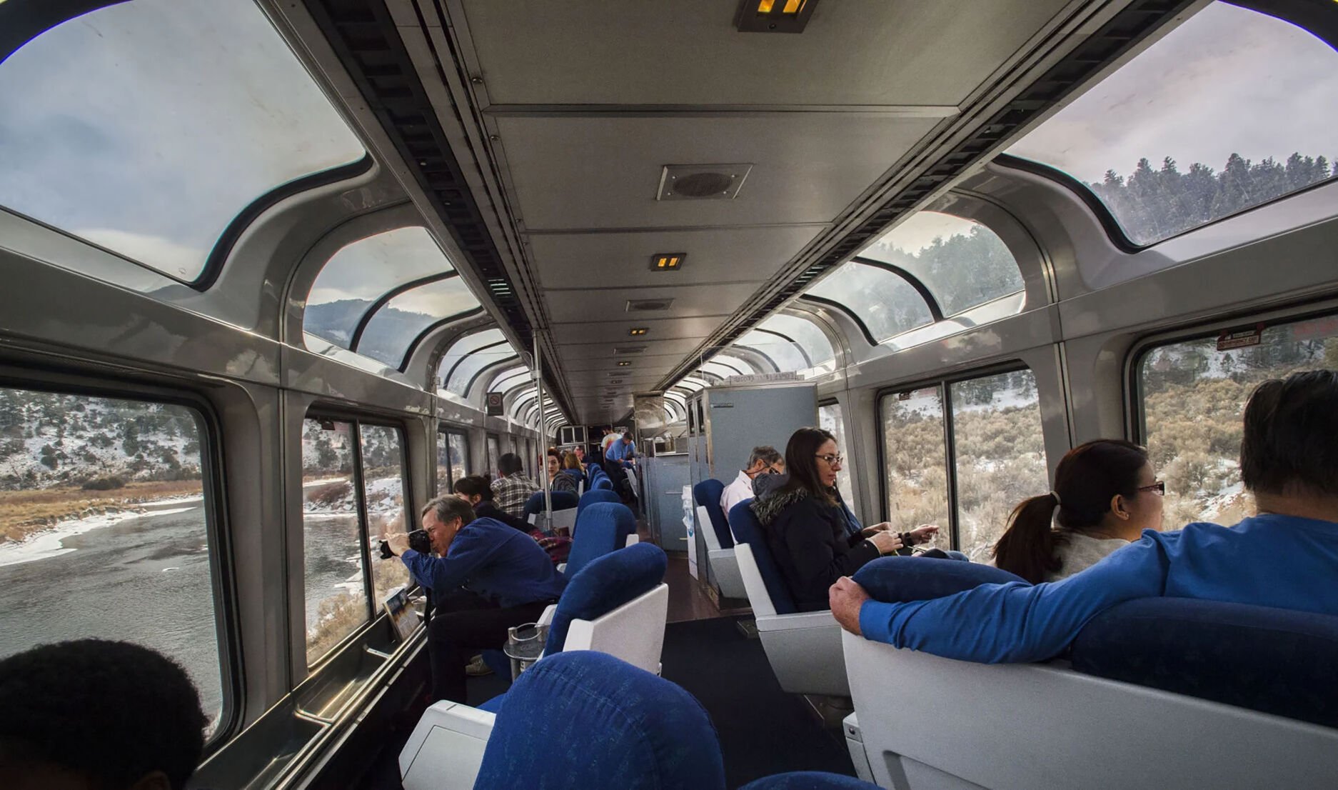 Passengers watch through the windows of the lounge car as the California Zephyr train rolls through the Colorado Rockies toward Glenwood Springs on Dec. 3, 2016. (christian murdock, gazette file)