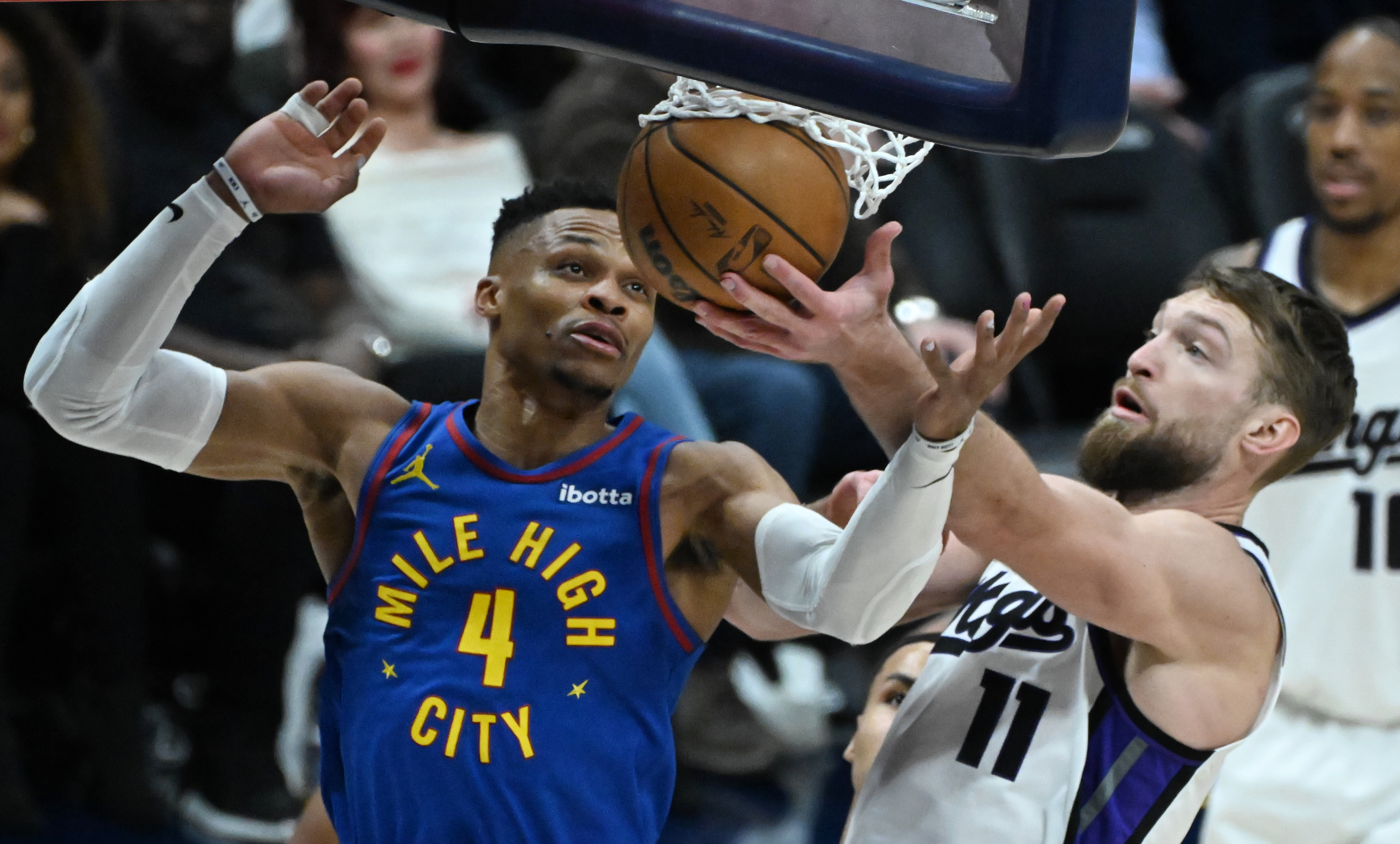 Denver Nuggets guard Russell Westbrook (4) and Sacramento Kings forward Domantas Sabonis (11) fight for a rebound during game at Ball Arena on Thursday, Jan. 23, 2025. The Nuggets defeated the Kings 132-123. (Jerilee Bennett,The Gazette)