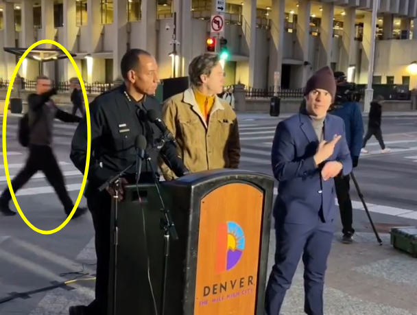 A heckler yells and Denver Mayor Mike Johnston during a news conference on Jan. 13, 2025. (Screenshot from Denver Police Department video)