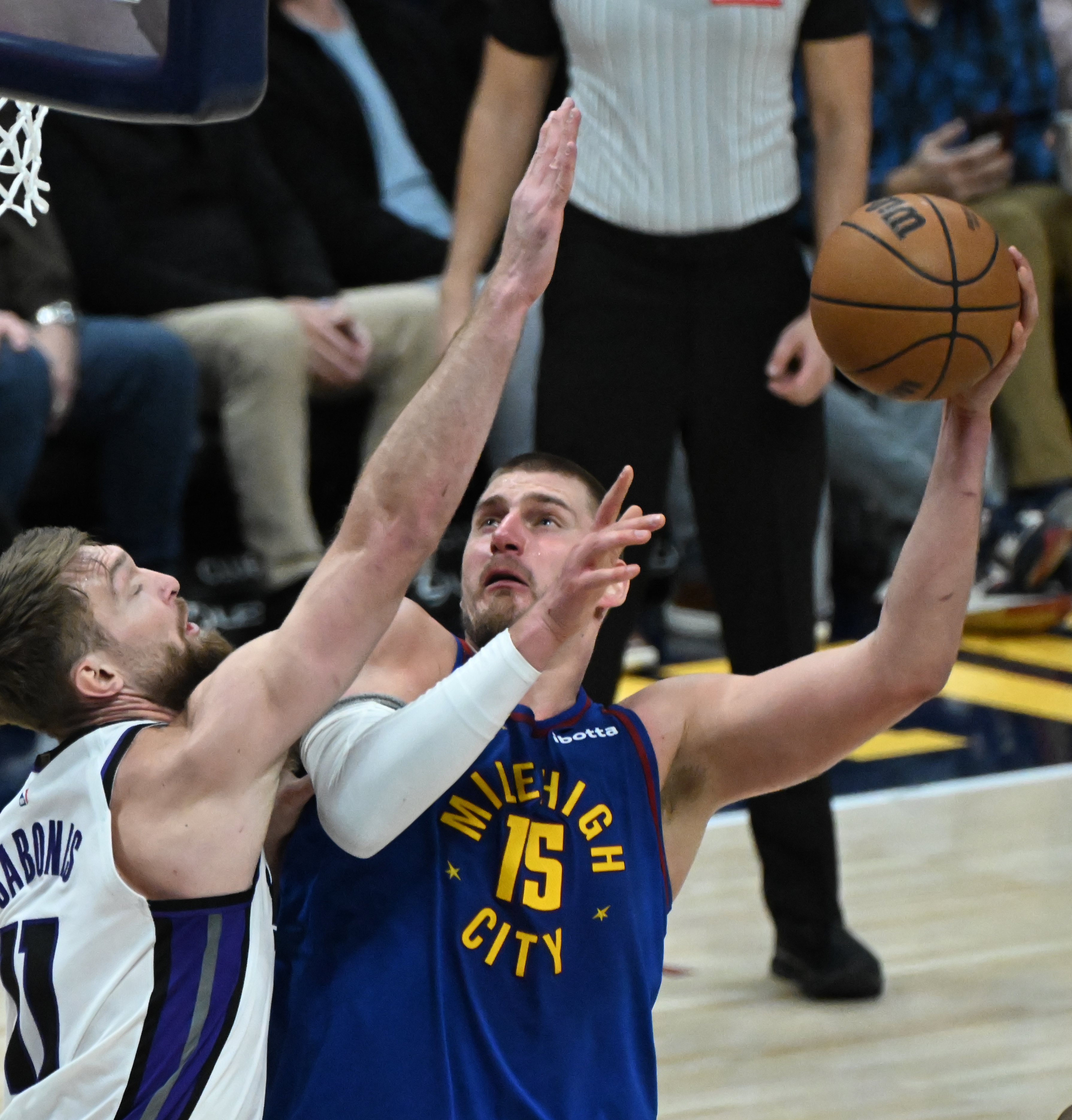 Denver Nuggets center Nikola Jokic (15) is pressured by Sacramento Kings forward Domantas Sabonis (11) on his way to shooting a basket during the 4th quarter of a game against the Kings at Ball Arena on Thursday, Jan. 23, 2025. (Jerilee Bennett,The Gazette)