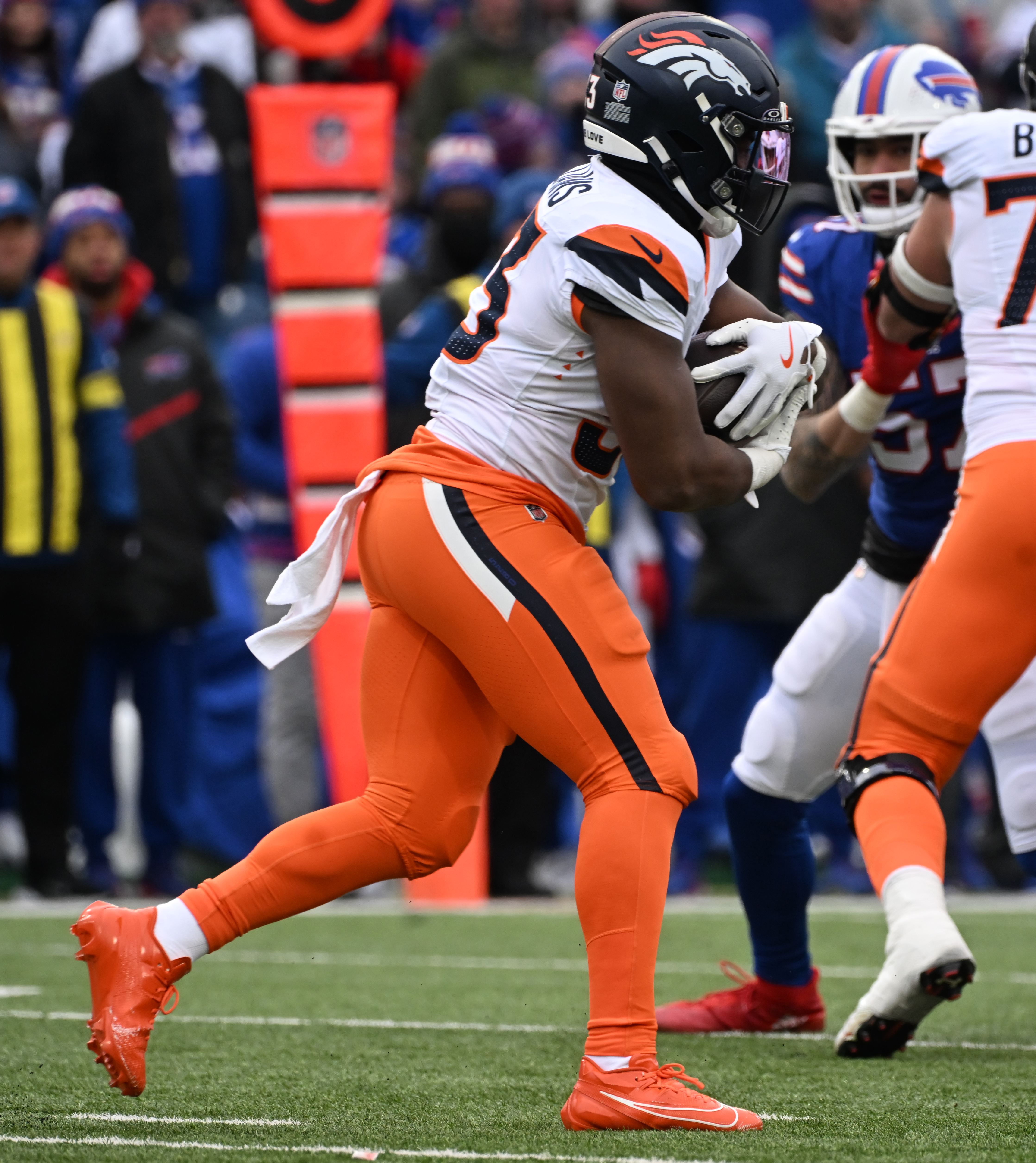 Denver Broncos running back Javonte Williams (33) runs with the ball during the wild card playoff game against the Bills in Buffalo on Sunday, January 12, 2024. The Broncos lost the game 31-7. (Jerilee Bennett,The Gazette)