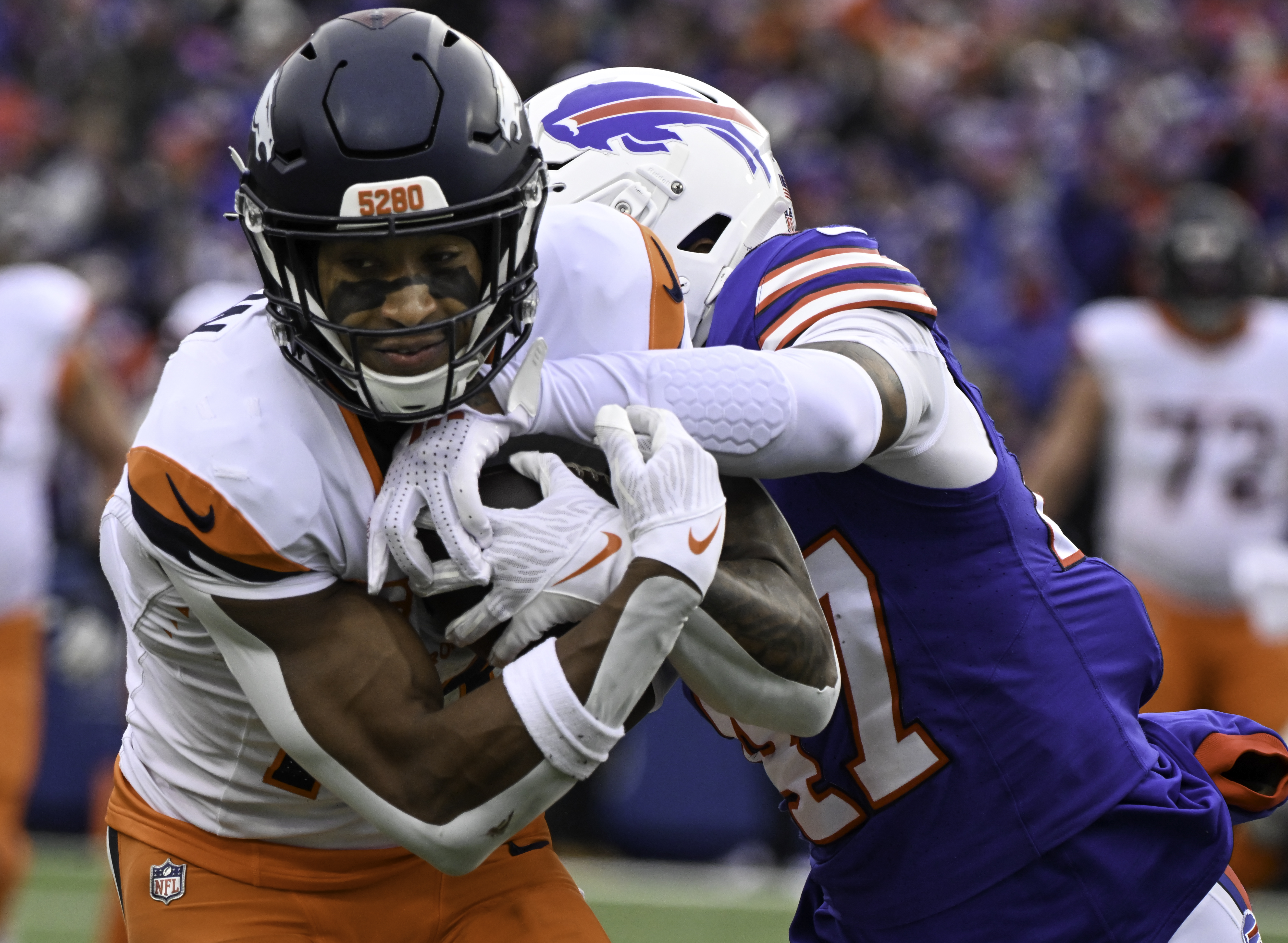Denver Broncos wide receiver Courtland Sutton (14) hauls in a catch for a first down while being defended by Buffalo Bills cornerback Christian Benford (47) during the second quarter of the wild card playoff game at Highmark Stadium in Buffalo on Sunday, Jan. 12, 2025. The Broncos lost 31-7. (Jerilee Bennett,The Gazette)