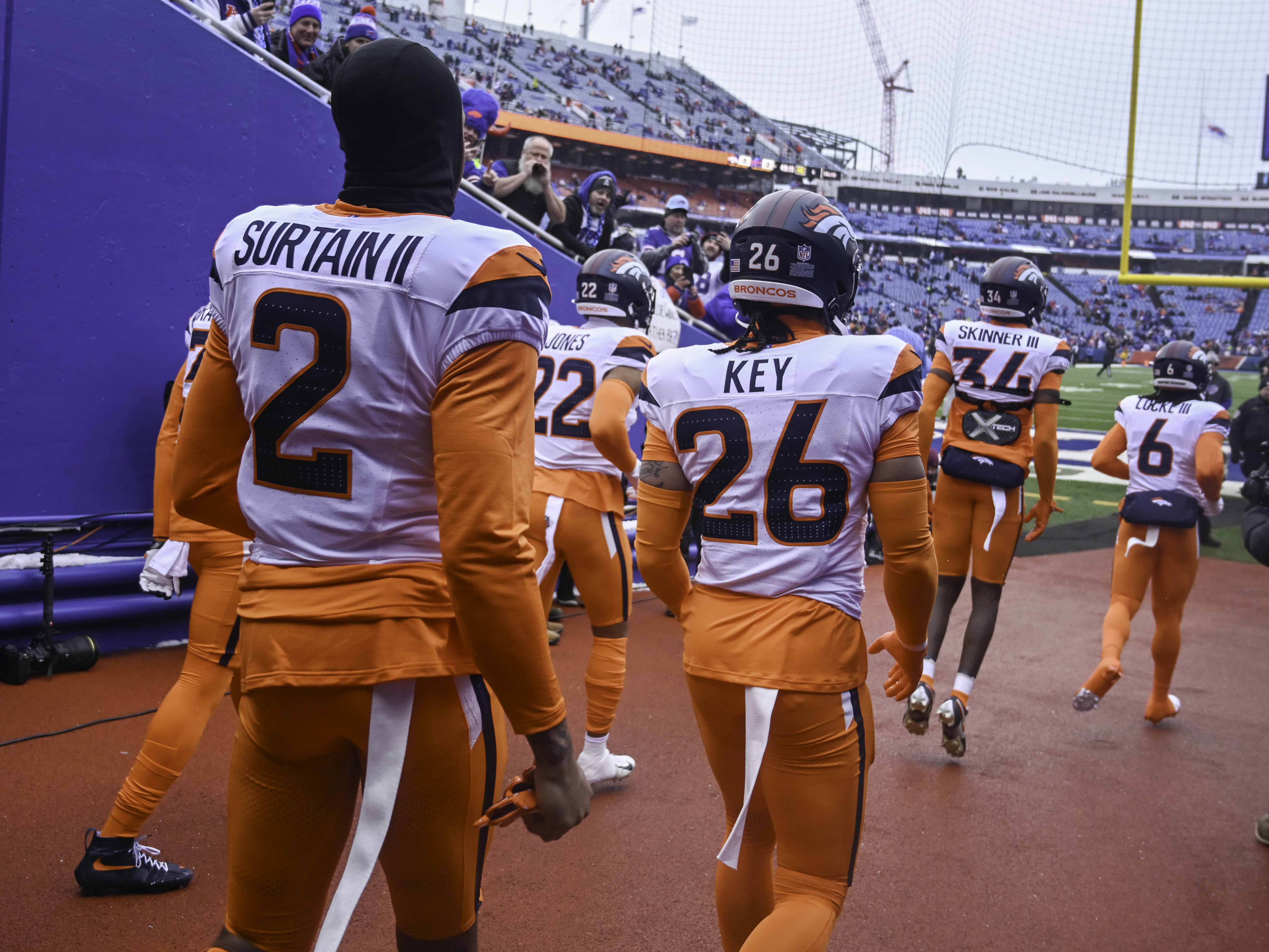 Denver Broncos cornerback Pat Surtain II (2) and other members of the Broncos defensive player take the field for warmups before the wild card playoff game between the Broncos and the Bills at Highmark Stadium in Buffalo on Sunday, Jan. 12, 2025. (Jerilee Bennett,The Gazette)