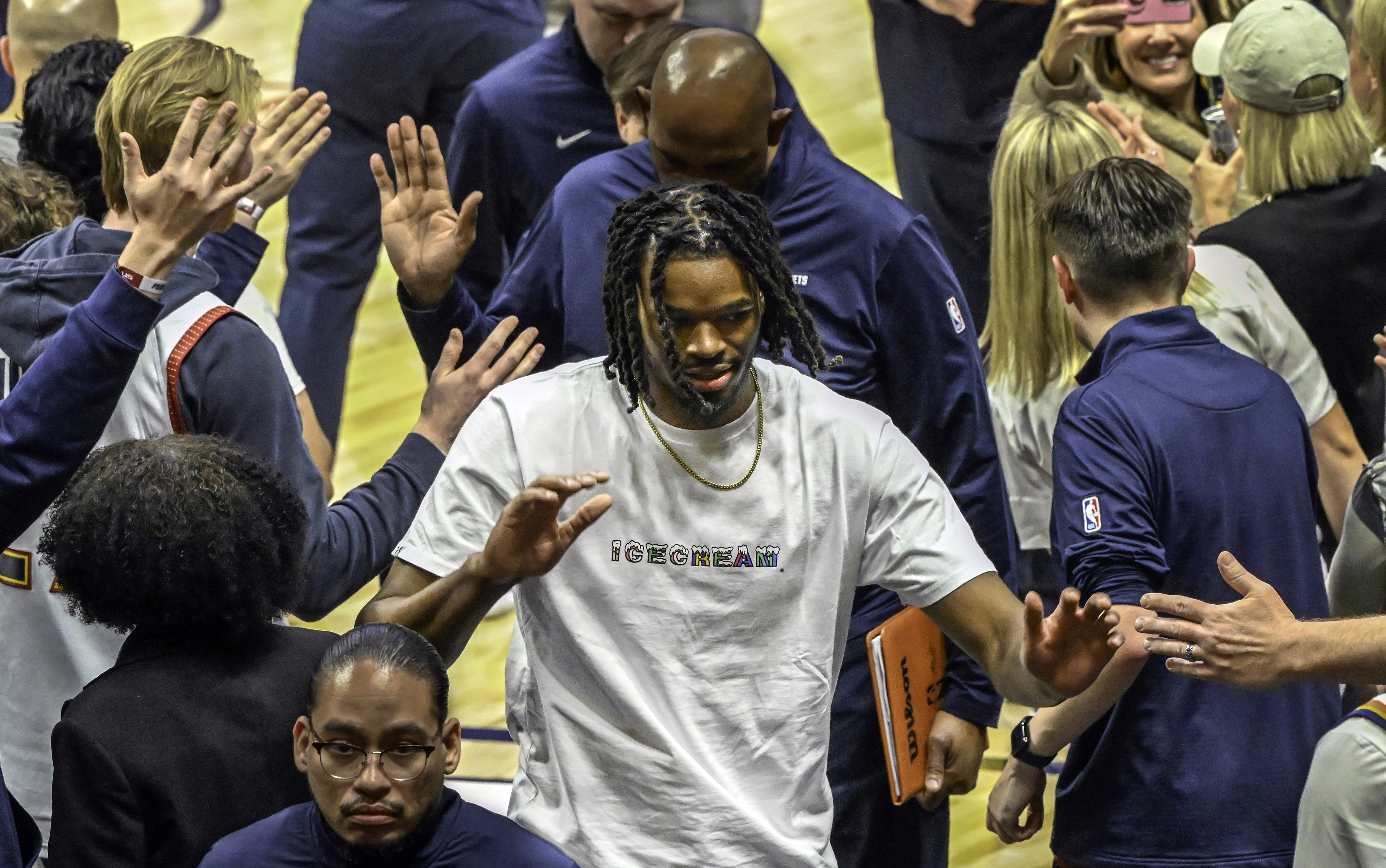 DaRon Holmes III high fives with the fans after the Nuggets-Pelican game from the bench at Ball Arena on Wednesday, February 5, 2025. (Jerilee Bennett, The Gazette)