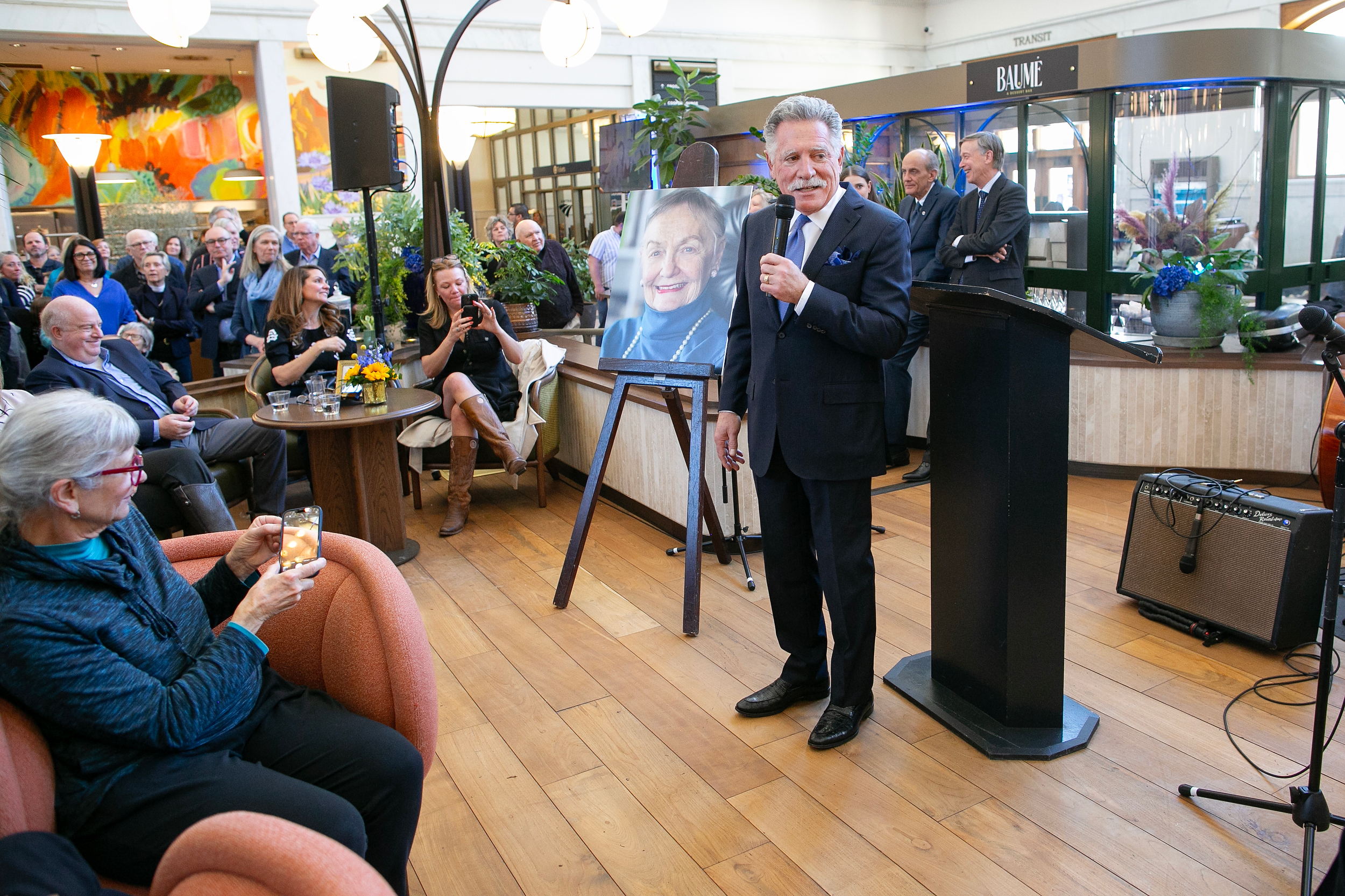 Walter Isenberg, Co-founder of the Sage Group, speaks to a packed crowd during the memorial service for Dana Crawford at Union Station in Downtown Denver, Colo., Sunday . Feb. 23, 2025. Crawford is considered to be one of the most influential preservationist and developers in Downtown Denver city’s history. (Photo by Bear Gutierrez) (Bear Gutierrez)