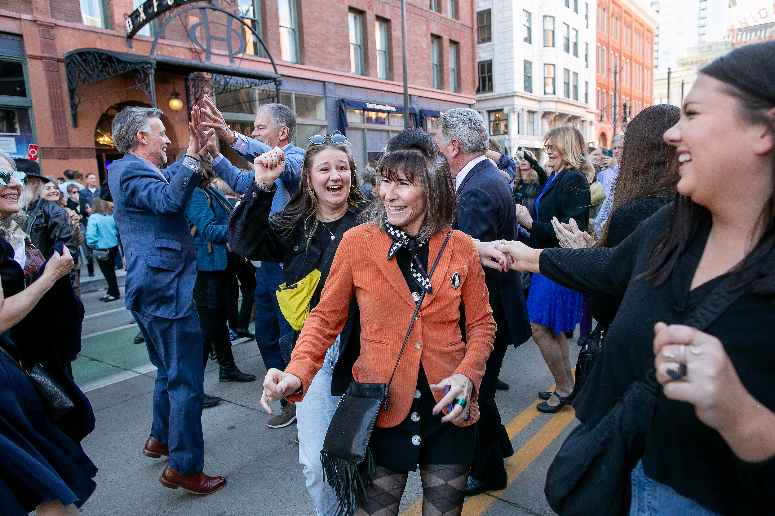 Friend and family dance to the tunes of a New Orleans-style jazz band along 17th street in front of Union Station to celebrate Dana Crawford for her memorial in Downtown Denver, Colo., Sunday . Feb. 23, 2025. Crawford is considered to be one of the most influential preservationist and developers in Downtown Denver city’s history. (Photo by Bear Gutierrez) (Bear Gutierrez)
