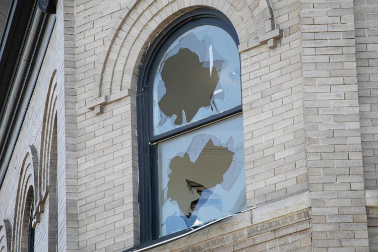 A window in the Austin apartment building on Colfax Ave. is broken out